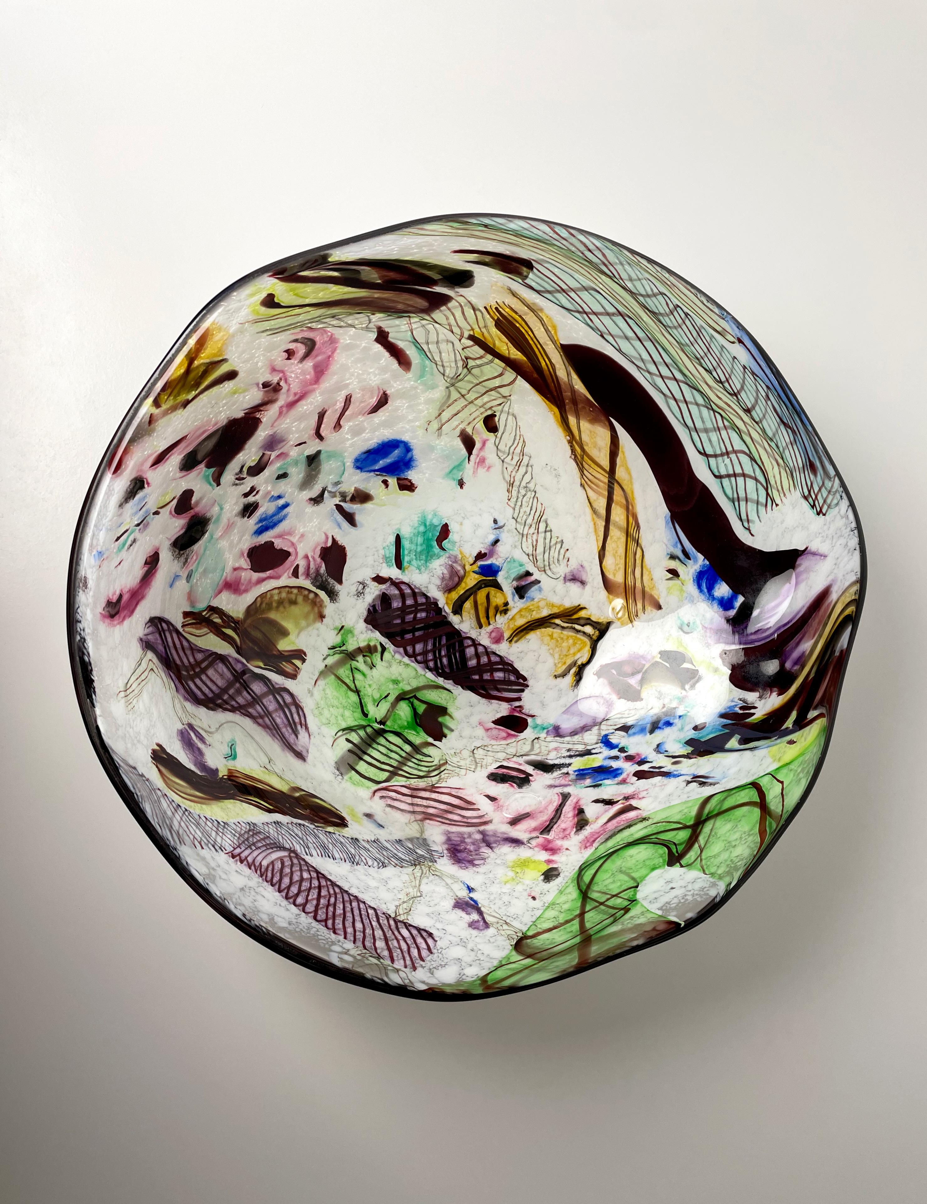 Stunning mouthblown bright colored art glass bowl created in Denmark's northernmost town, Skagen. Delicate lines, curves, patterns and ornamentations in a multitude of colors: Green, pink, cobalt blue, yellow, ochre, purple, maroon and aqua in an