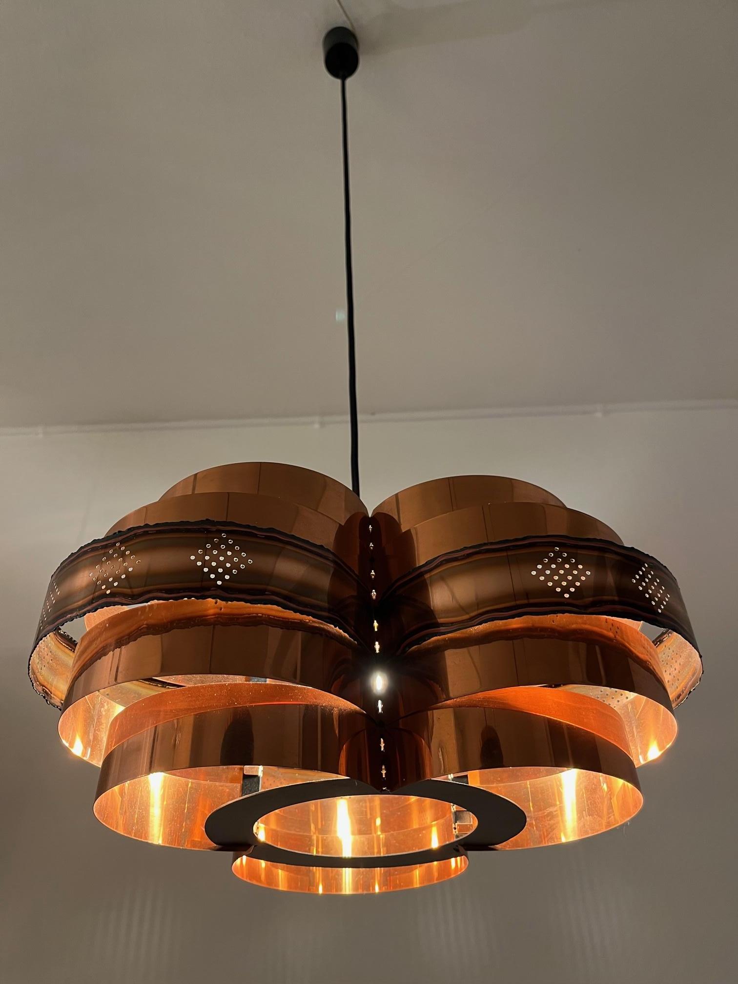 Decorative Copper Danish pendant lamp by Verner Schou produced by Coronell Elektro ca. 1960s
Warm light, very good condition
Diameter : 40 Total Height : 120 cm ( adjustable ) Height shade : 20 cm.
 