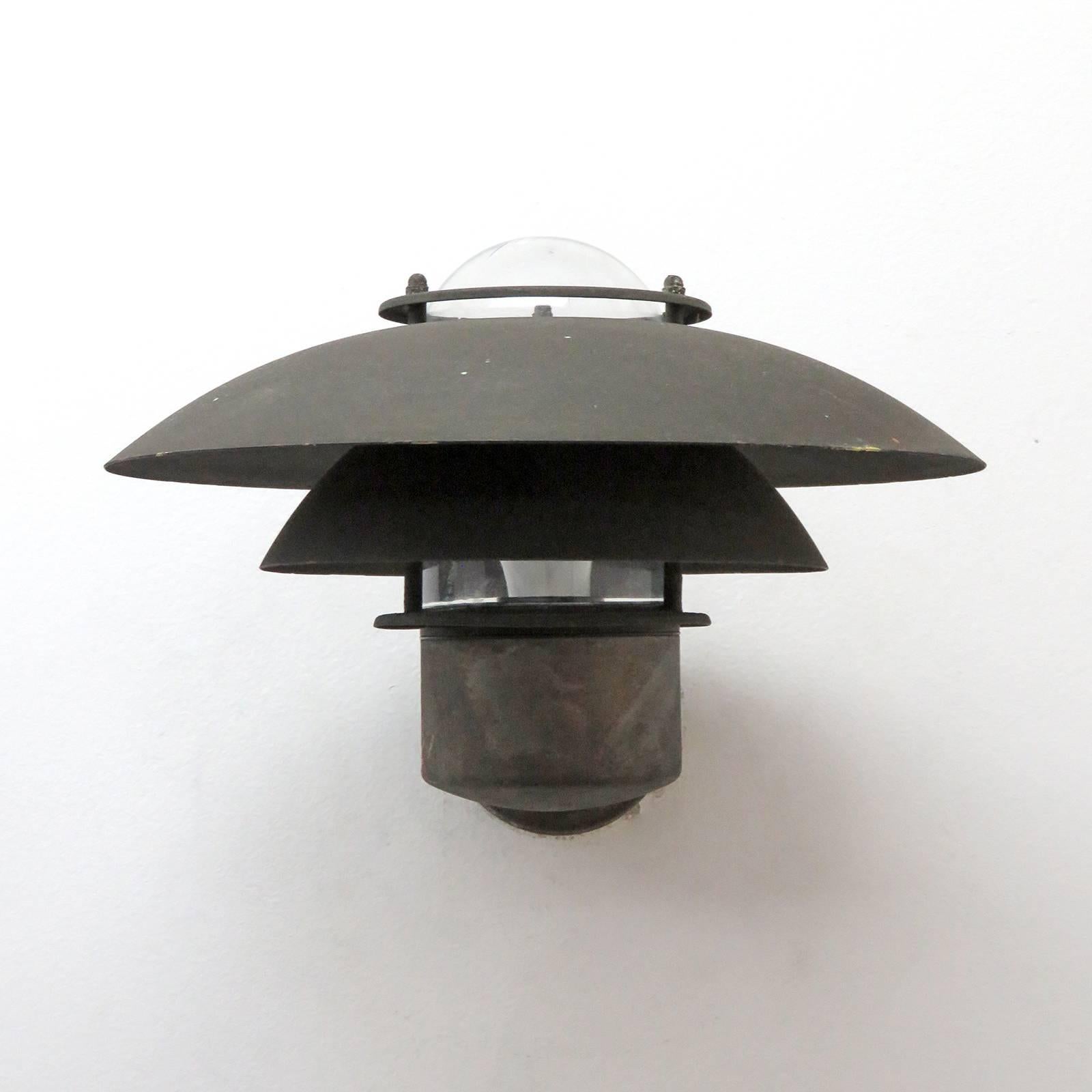 Wonderful Danish outdoor wall lights by Form Light in weathered copper with glass bulb enclosures. Priced individually.