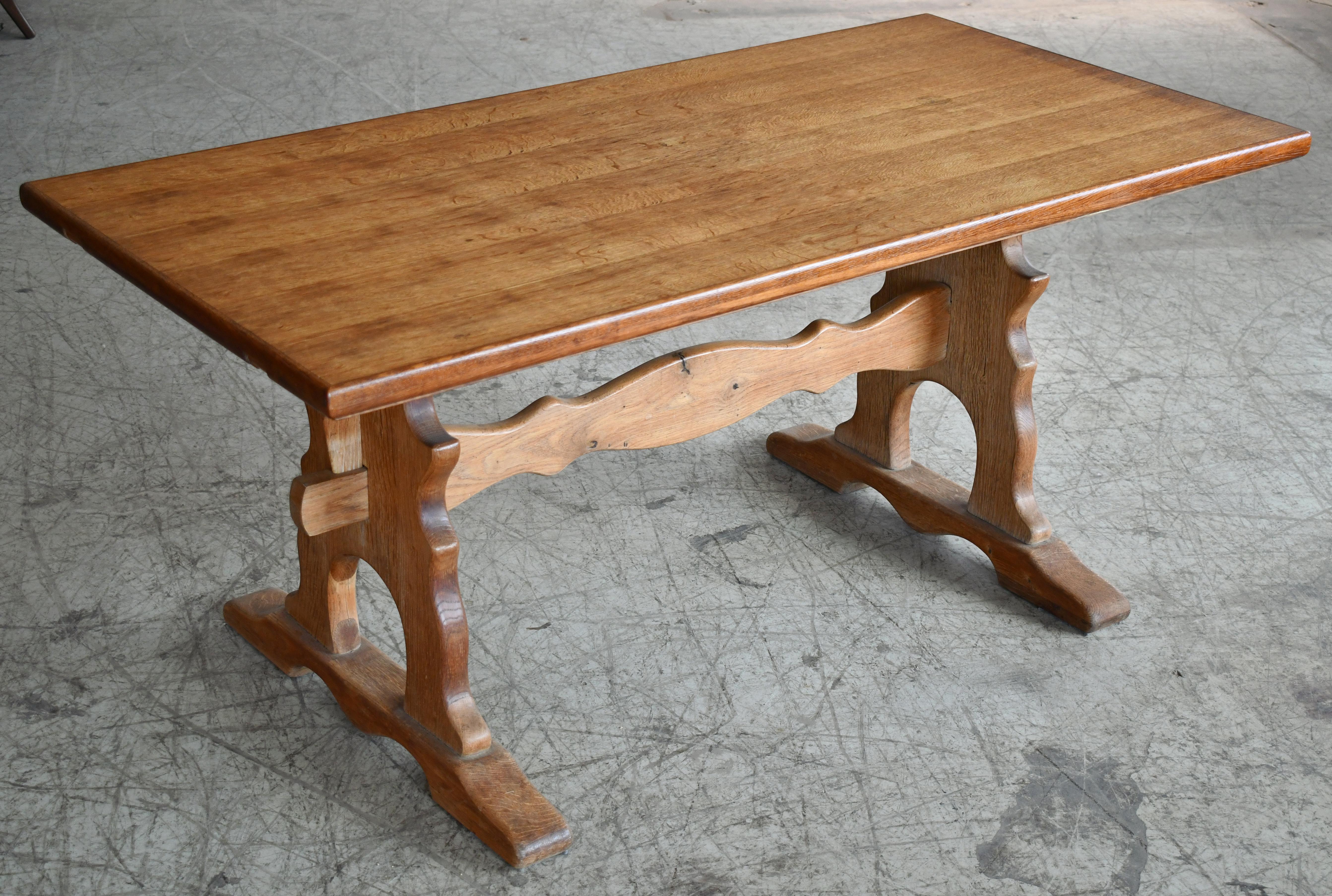 Great dining table in solid oak made in Denmark probably around 1960's. These style table was common from about 1880 and found popularity again in the 1960's and 70's. We believe this is if the newer kind based on the size and signs of wear. Great