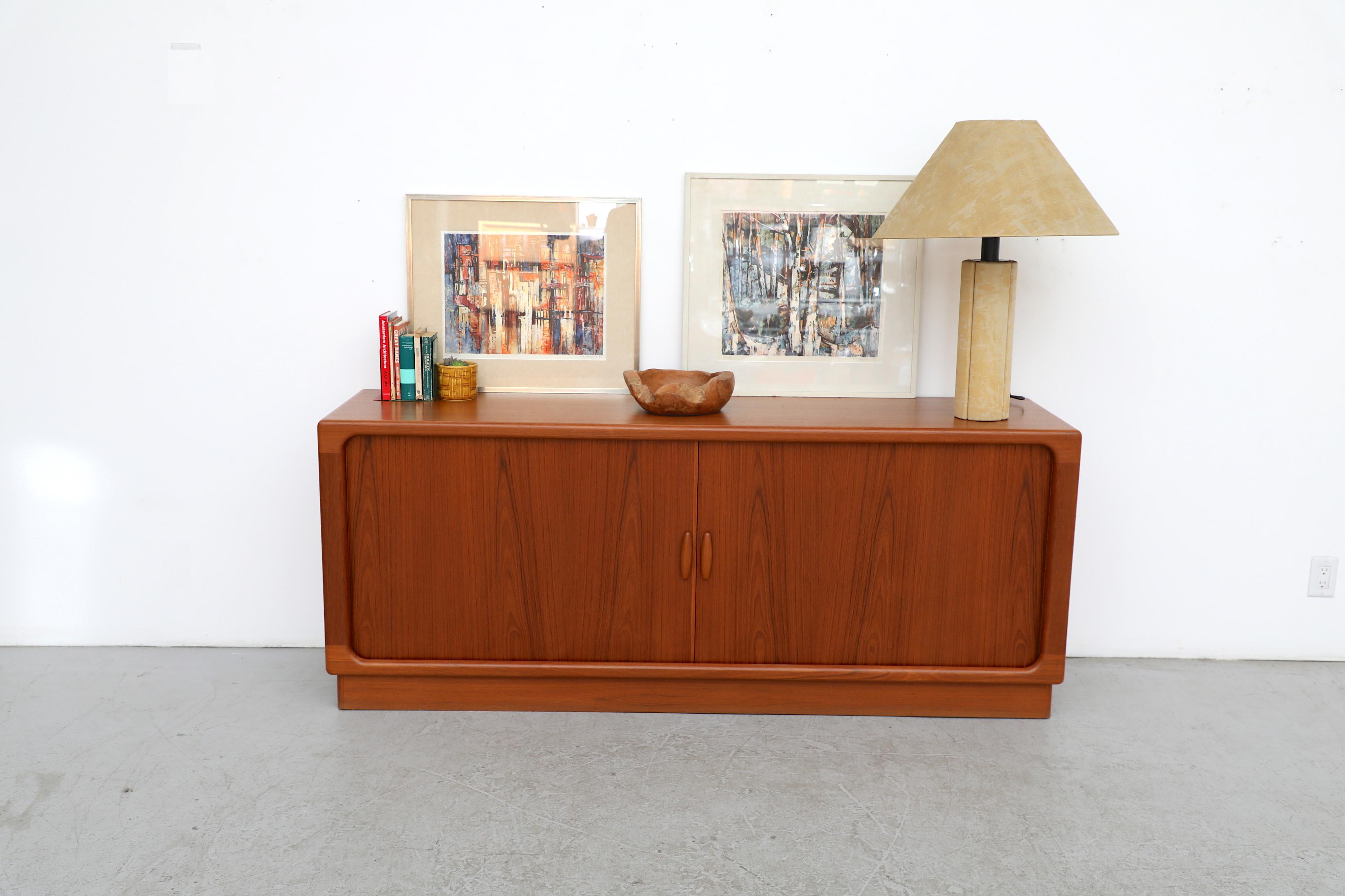 Beautiful 1960's Danish teak credenza with tambour doors manufactured by Dyrlund. The interior has 5 shelves and 5 felt lined pull out drawers with dovetail joints. In good original condition. Wear is consistent with its age and use. 