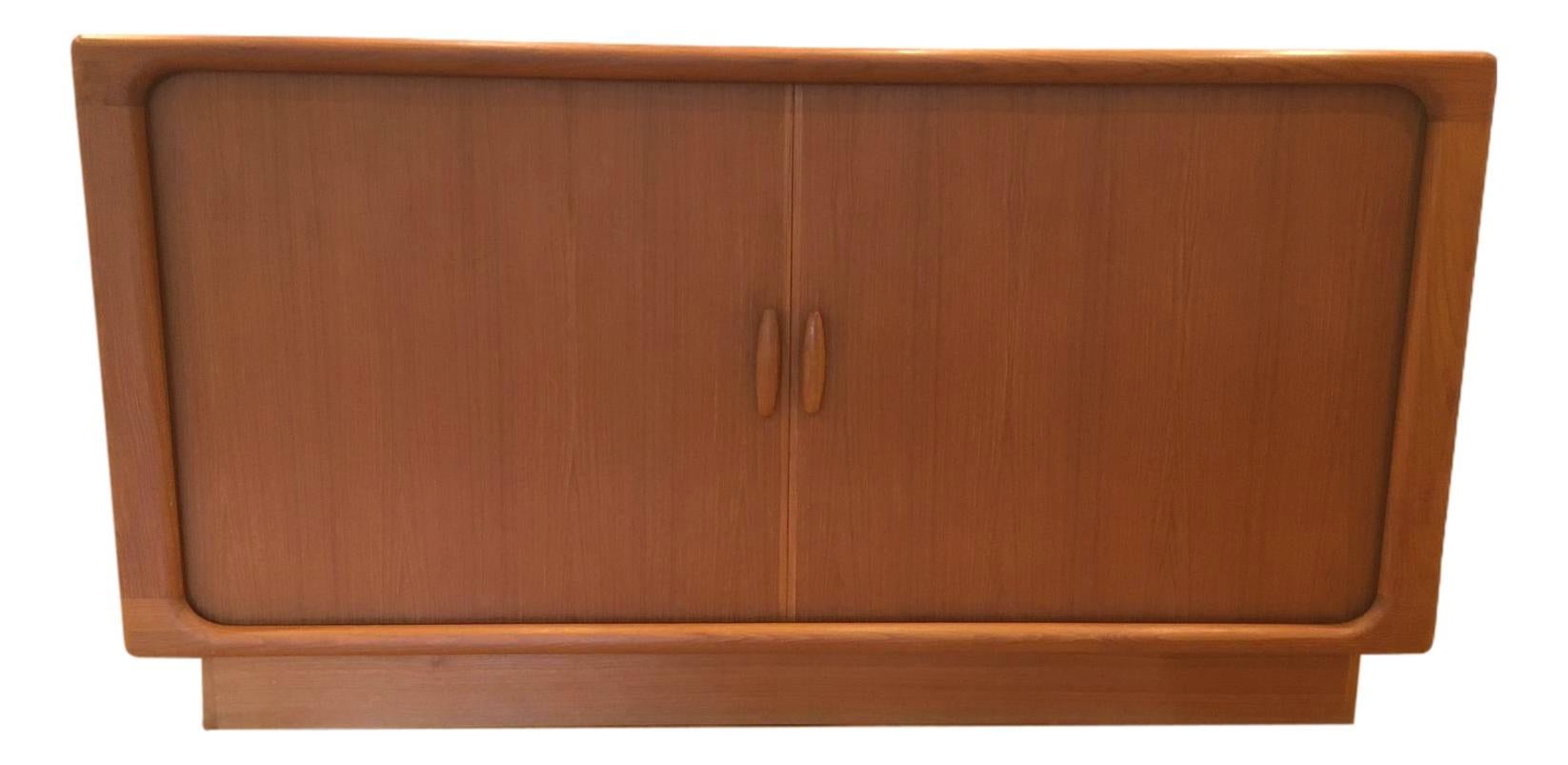 Mid century credenza, with tambour doors, designed and manufactured by Dyrlund of Denmark. Produced in beautifully grained Teak this piece is another classic example of Dyrlund's Craftsmanship. The sheer quality of the finish is why they were one of