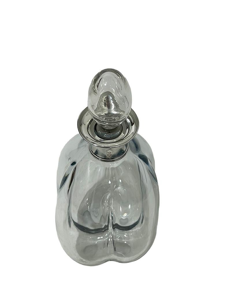 Danish Crystal Decanter with silver neck mount , Denmark, 1960s

An organic in four round shapes decanter/carafe with silver neck mount and a glass stopper. The silver was made by Sölvvarefabriken Kronen, 1963-1975, Copenhagen. Marked with