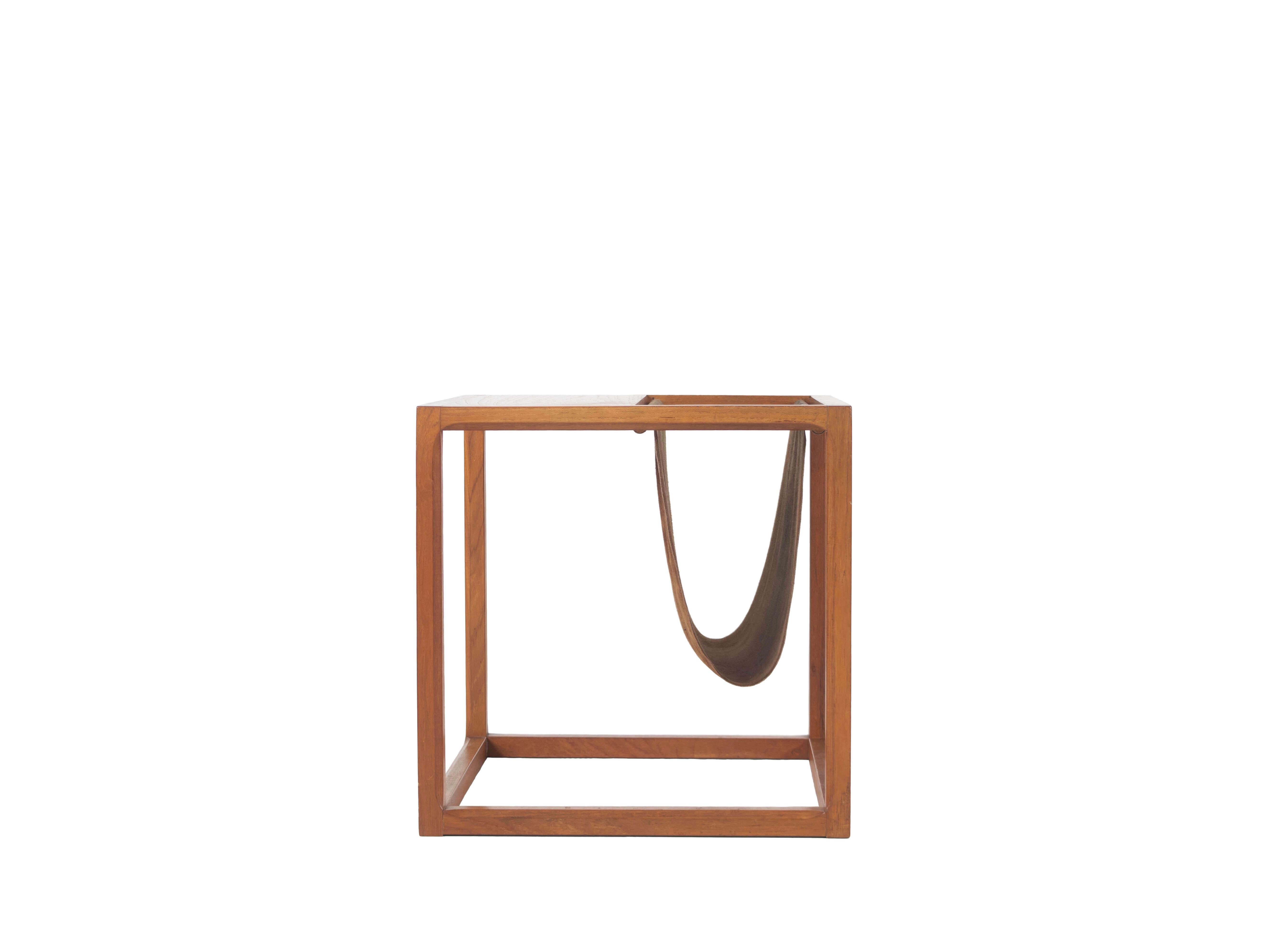 Danish Cube magazine rack / side table by Kai Kristiansen from the 1960s. This side table is made of teak wood and brown leather. The details of the table are very nice; each sidebar has rounded/curved edges. One of my personal favorites in terms of