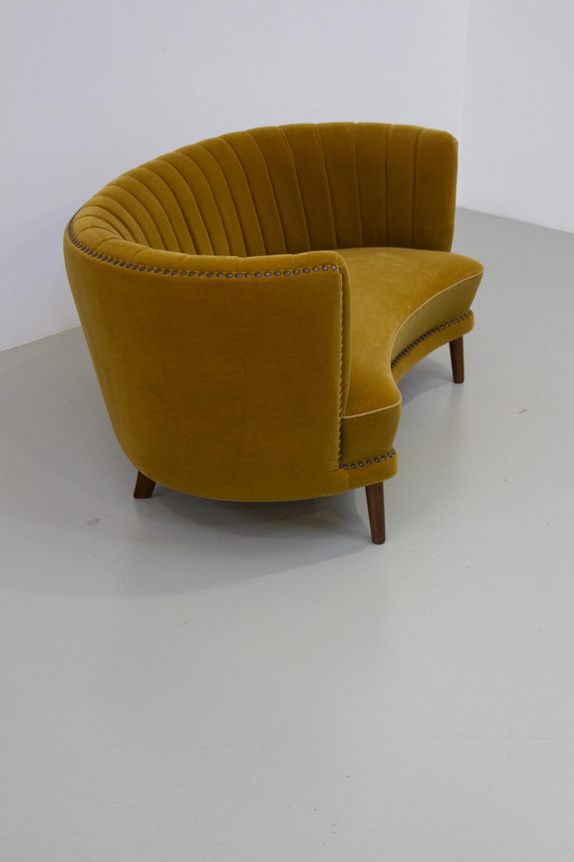 Danish Curved Banana Sofa in Velour, 1950. 

Wonderful Danish Mid-Century Modern two-seater banana sofa in yellowish velvet fabric. This sofa represents the transition period between Danish Art Deco and Scandinavian Mid-Century Modern which can be