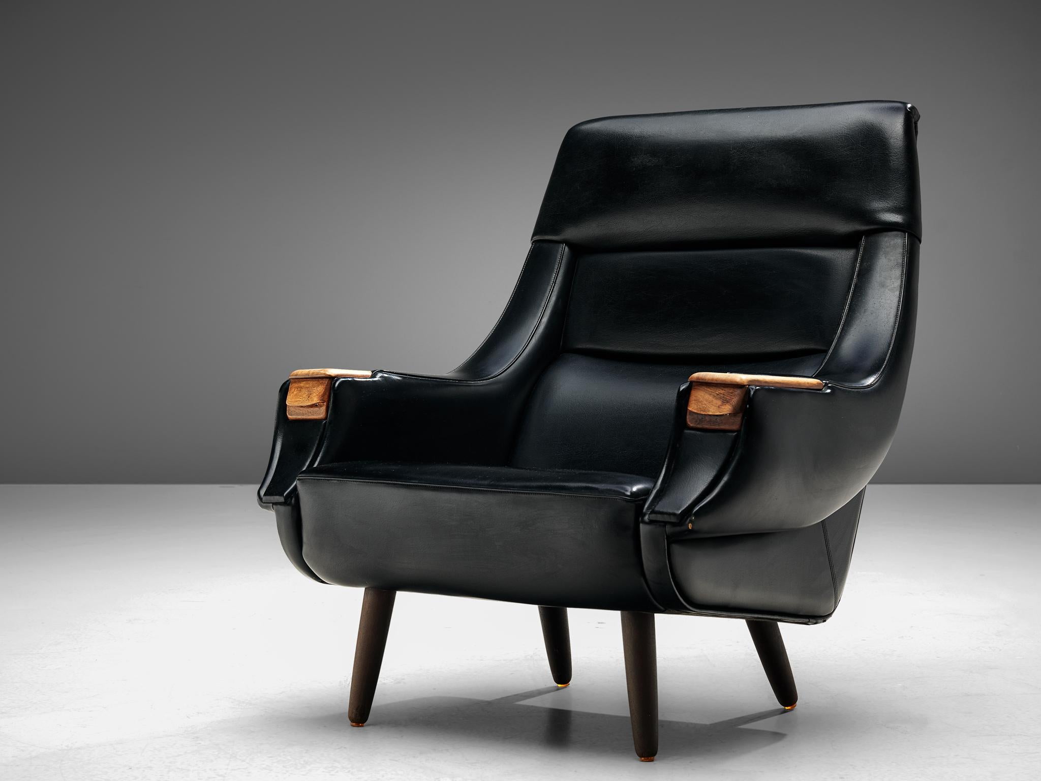 Henry Walter Klein for Bramin, lounge chair, black leatherette, wood, Denmark, 1960s.

Robust and comfortable lounge chair by the Danish designer H.W. Klein. The slightly curved shape of the backrest has a highly inviting appearance. The chair has