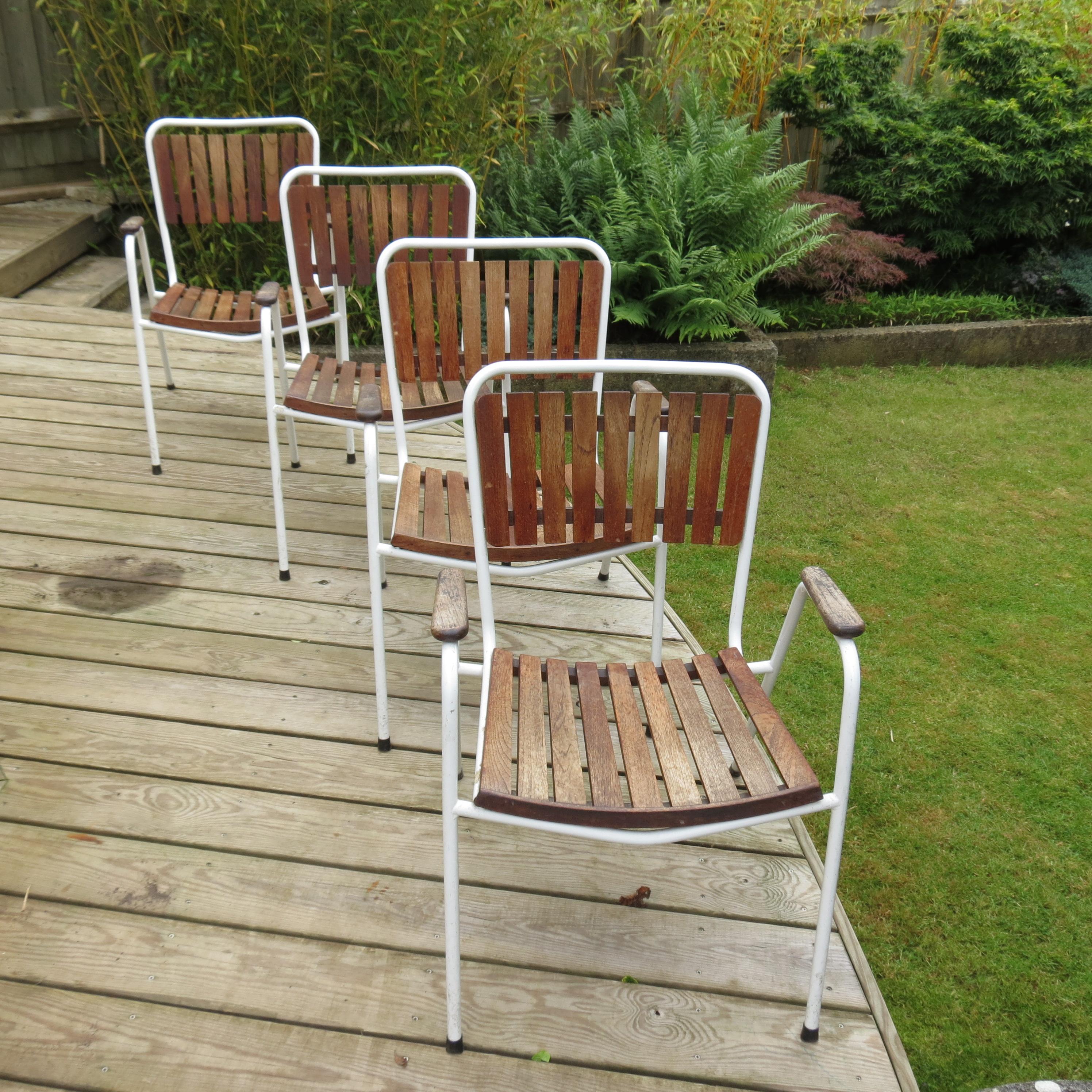 Set of 4 garden chairs by Daneline, Denmark.  Made from painted steel tube frames and Teak slatted seat and back rest.  The chairs stack for ease of storage.
In good condition, with only minimal signs of use.

ST1042.
