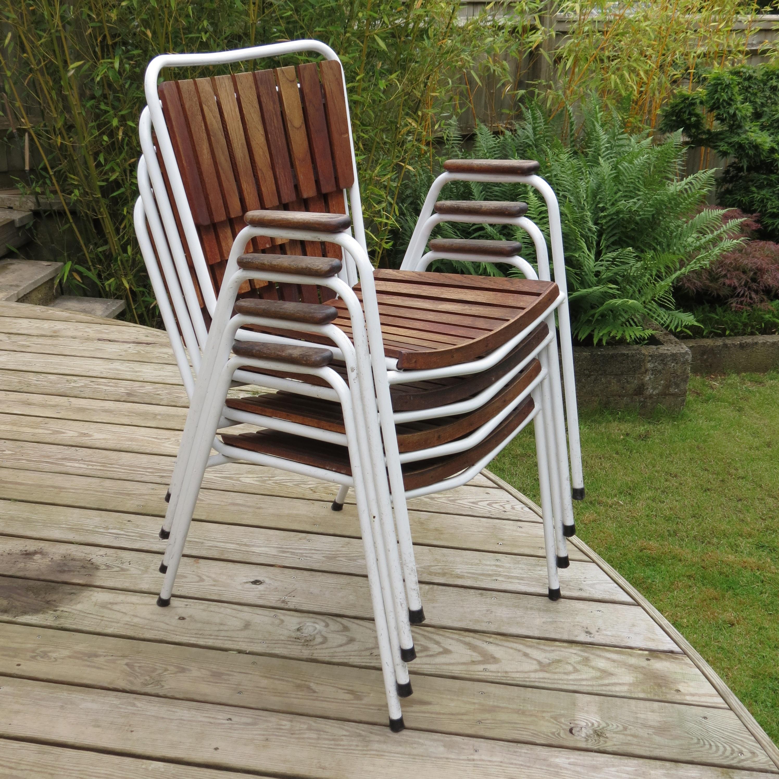 Set of 4 garden chairs by Daneline, Denmark. Made from painted steel tube frames and teak slatted seat and backrest. The chairs stack for ease of storage.
In good vintage condition, some signs of wear to the metal frames, teak slats in good