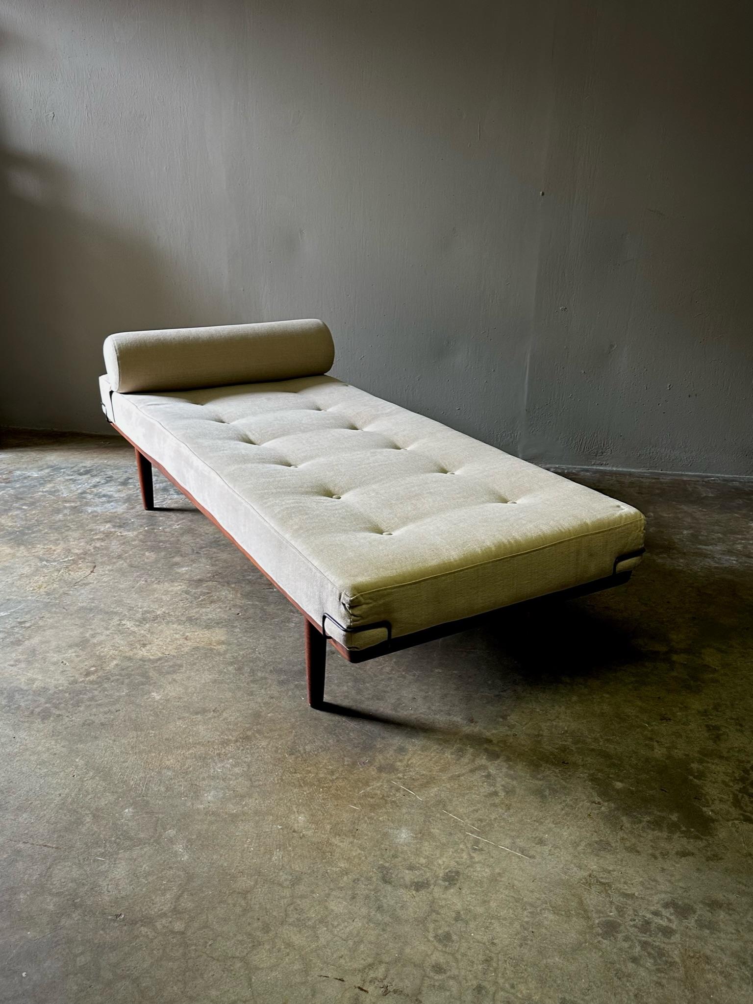 Rare Danish midcentury daybed by Frem Rojle, with sleek modern lines, wood base and ecru upholstered seat cushion with bolster pillow. Sensuous yet minimal. 

Denmark, circa 1960

Dimensions: 74W x 29D x 17H
