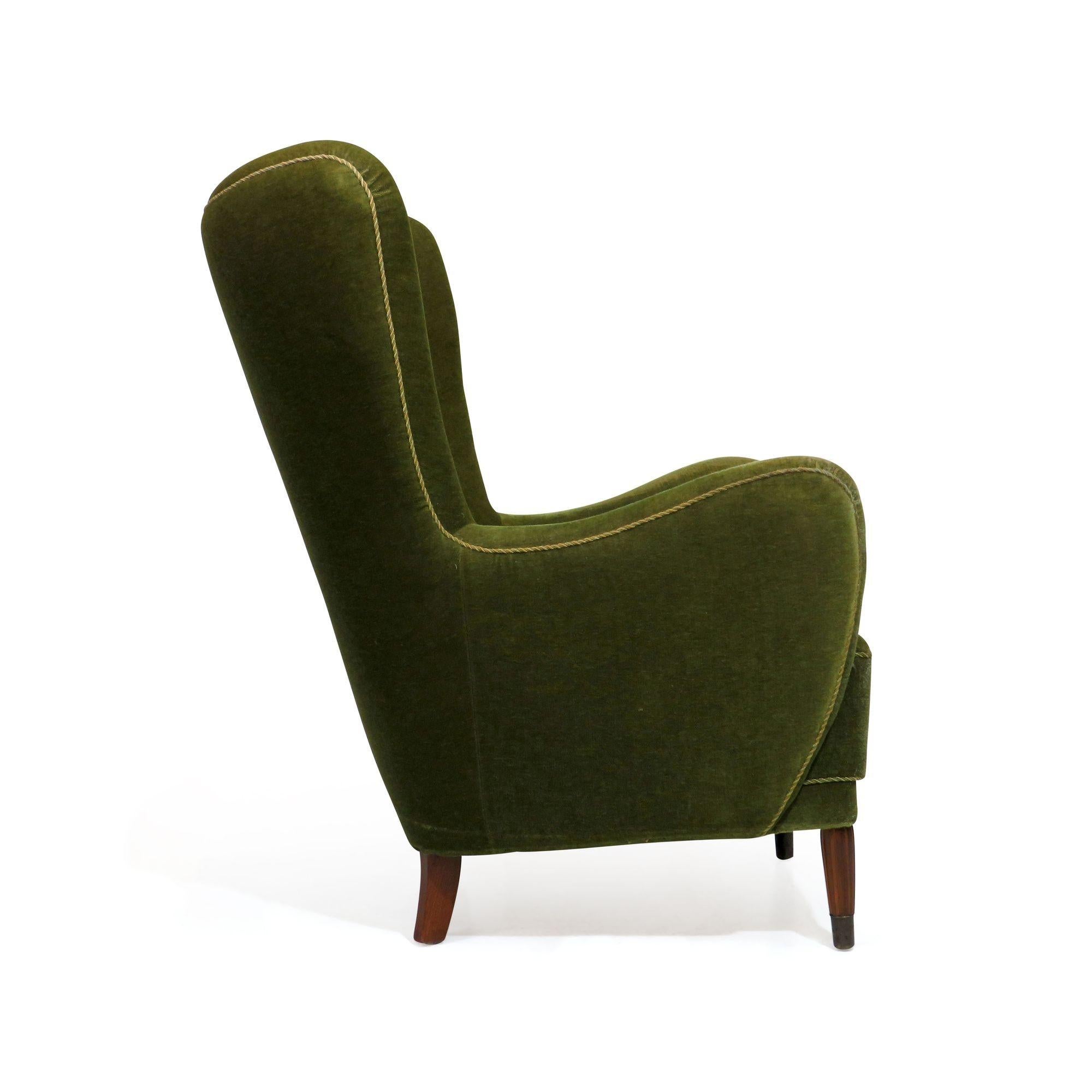 1940's Danish high back lounge chair constructed of a solid wood frame with hand-tied springs and horsehair padding, upholstered in the original green mohair fabric. Excellent back support and comfortable seating.
 
Seat Height 17.25''.