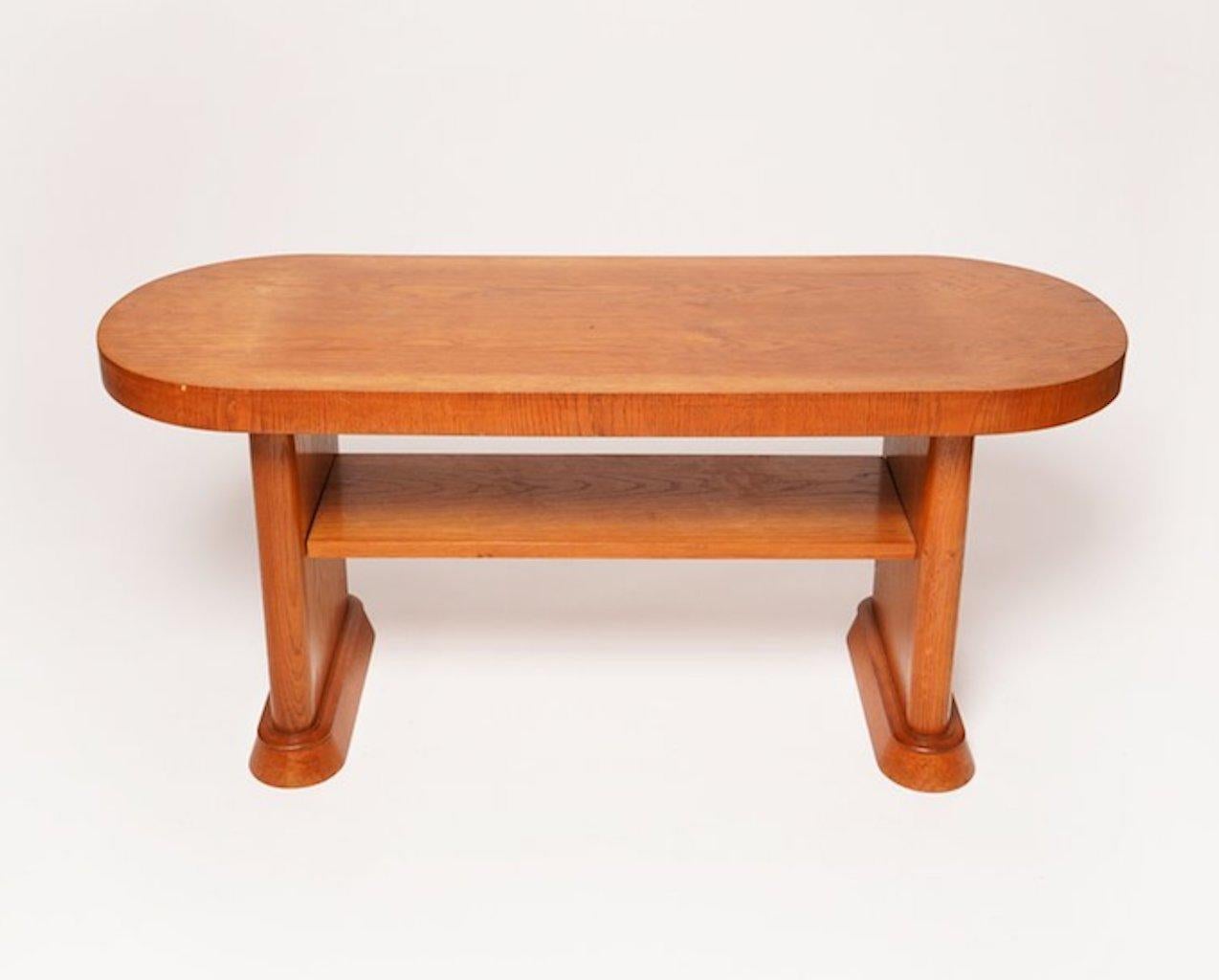 This beautiful Danish Deco low console table features rounded ends and a shelf. This piece would serve nicely as a low console and/or coffee table.

 