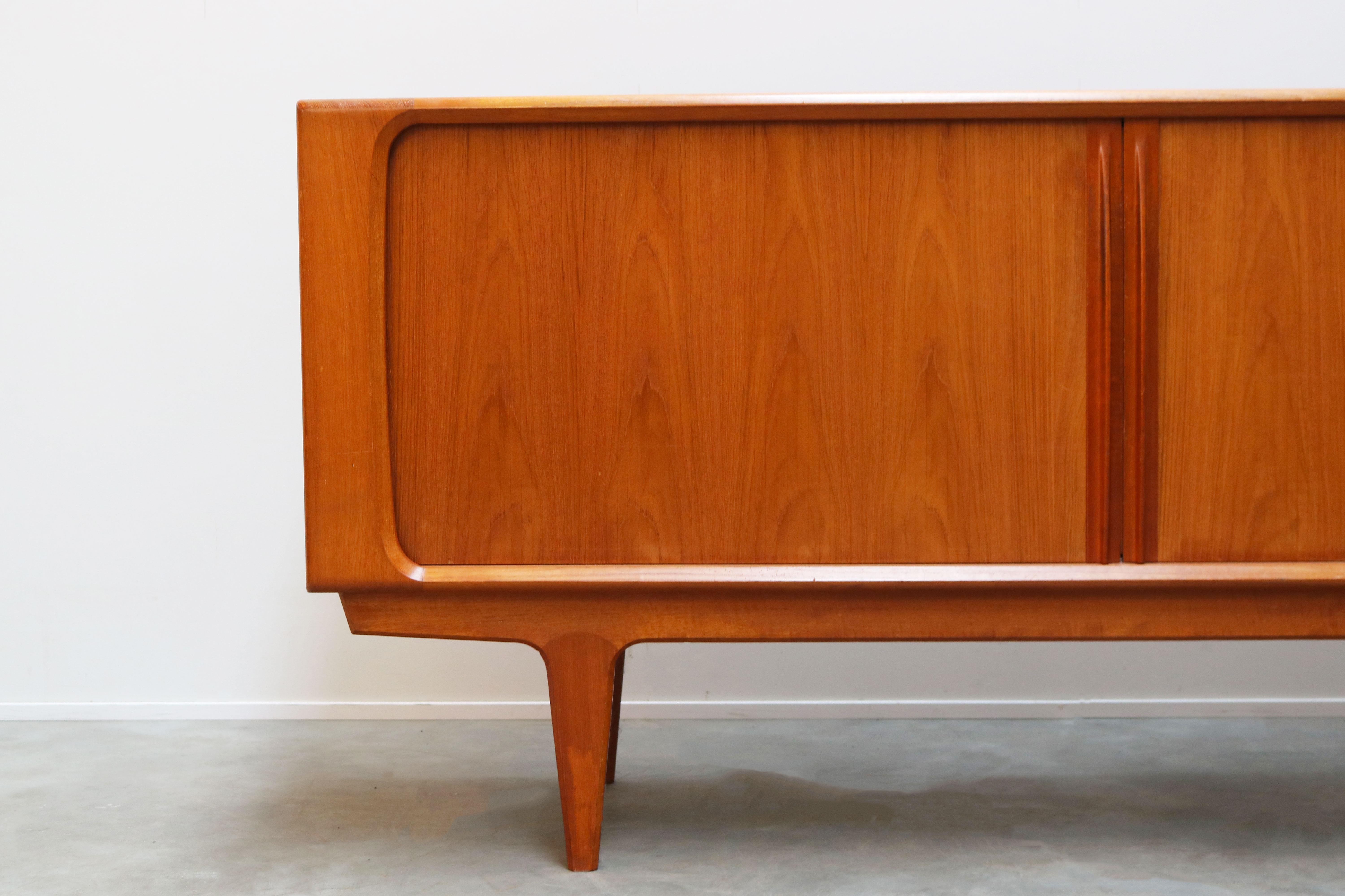 Gorgeous Danish design credenza/sideboard in teak Designed & produced by Bernhard Pedersen.
Bernhard pedersen is known for very high quality Danish furniture and this piece perfectly reflects that.
The tambour doors disappear completely when