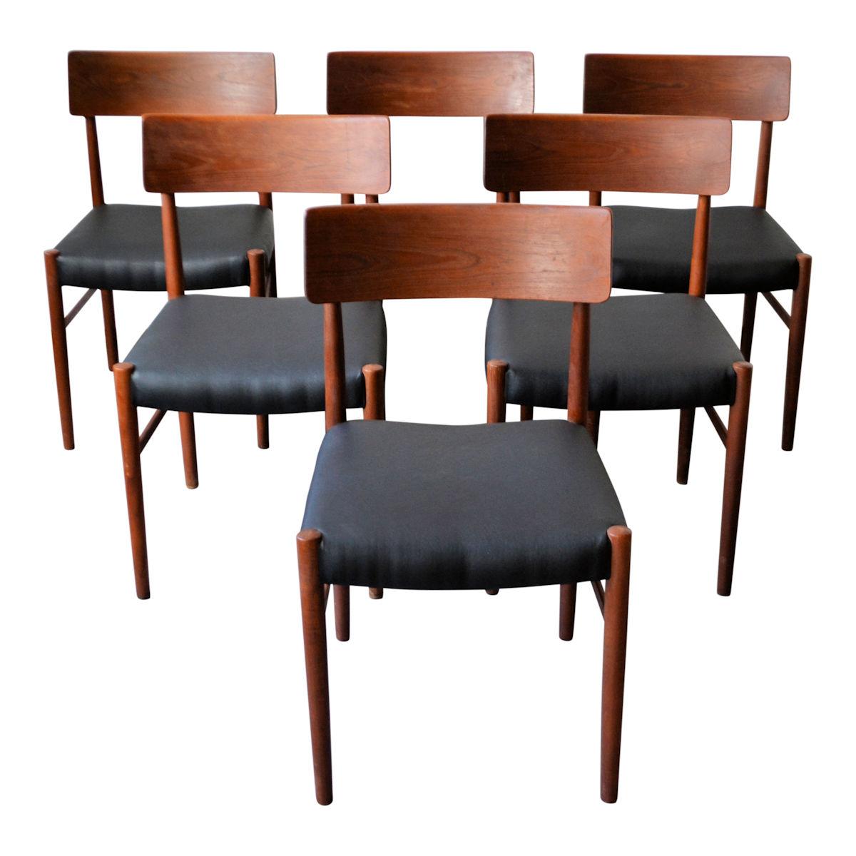 Set of six vintage Danish design dining chairs produced by Farstrup. These teak and beech chairs have a characteristic functional design, solid frames, and new black Skai leather upholstery. Gorgeous high-quality design pieces that will make a