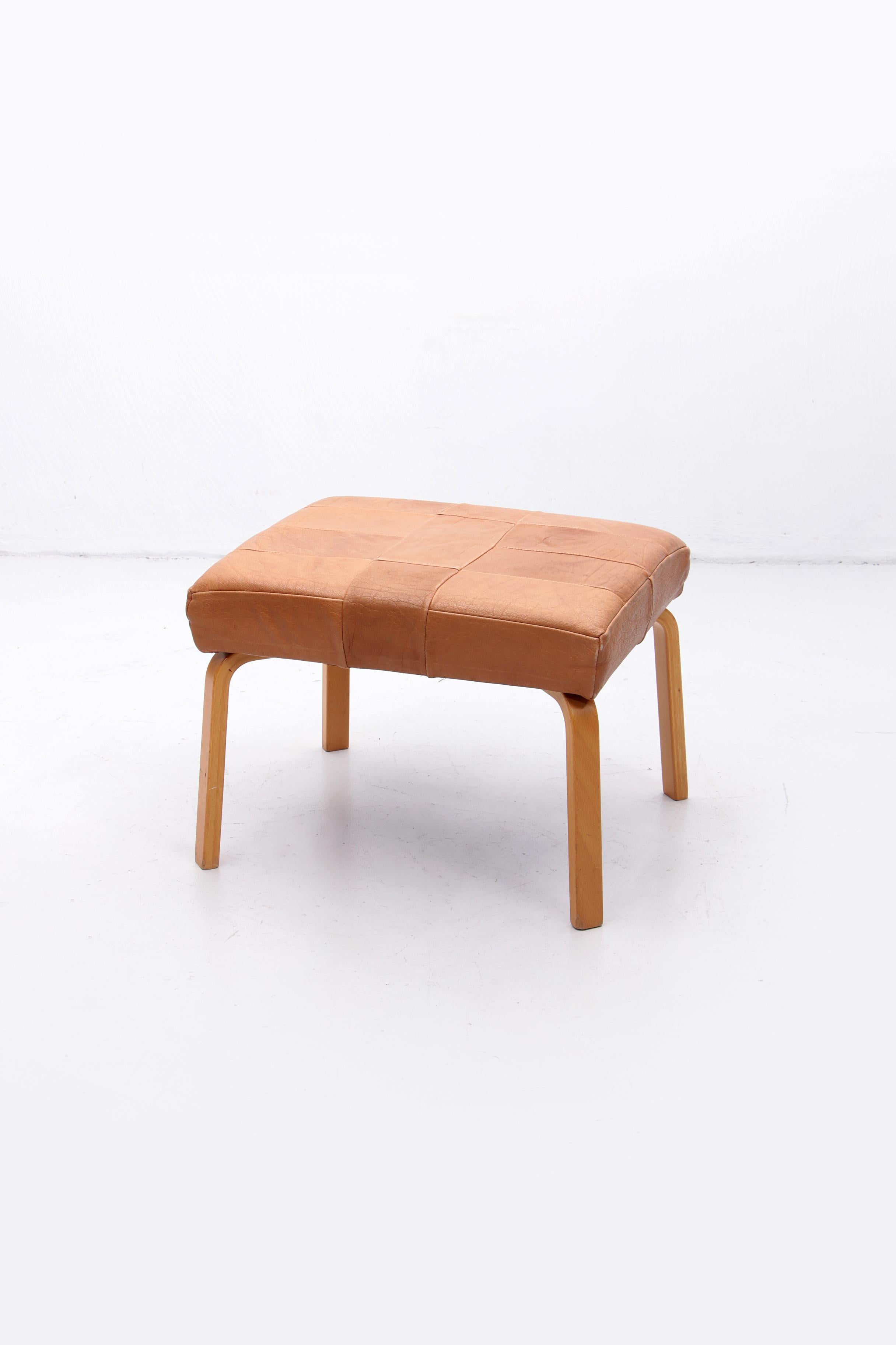 This is a very solid footstool with a leather cushion, beautifully made with leather pieces. Light brown and beautiful wooden legs. The brand is stouby.

Sustainable: environmentally conscious by supplementing your interior with vintage furniture,