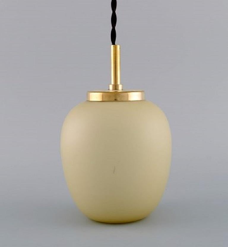 Danish design. Four China lamps or pendants made of matt opal glass with brass mounting, 
1960s.
Measures: 18 x 12 cm (inc brass).
In excellent condition.