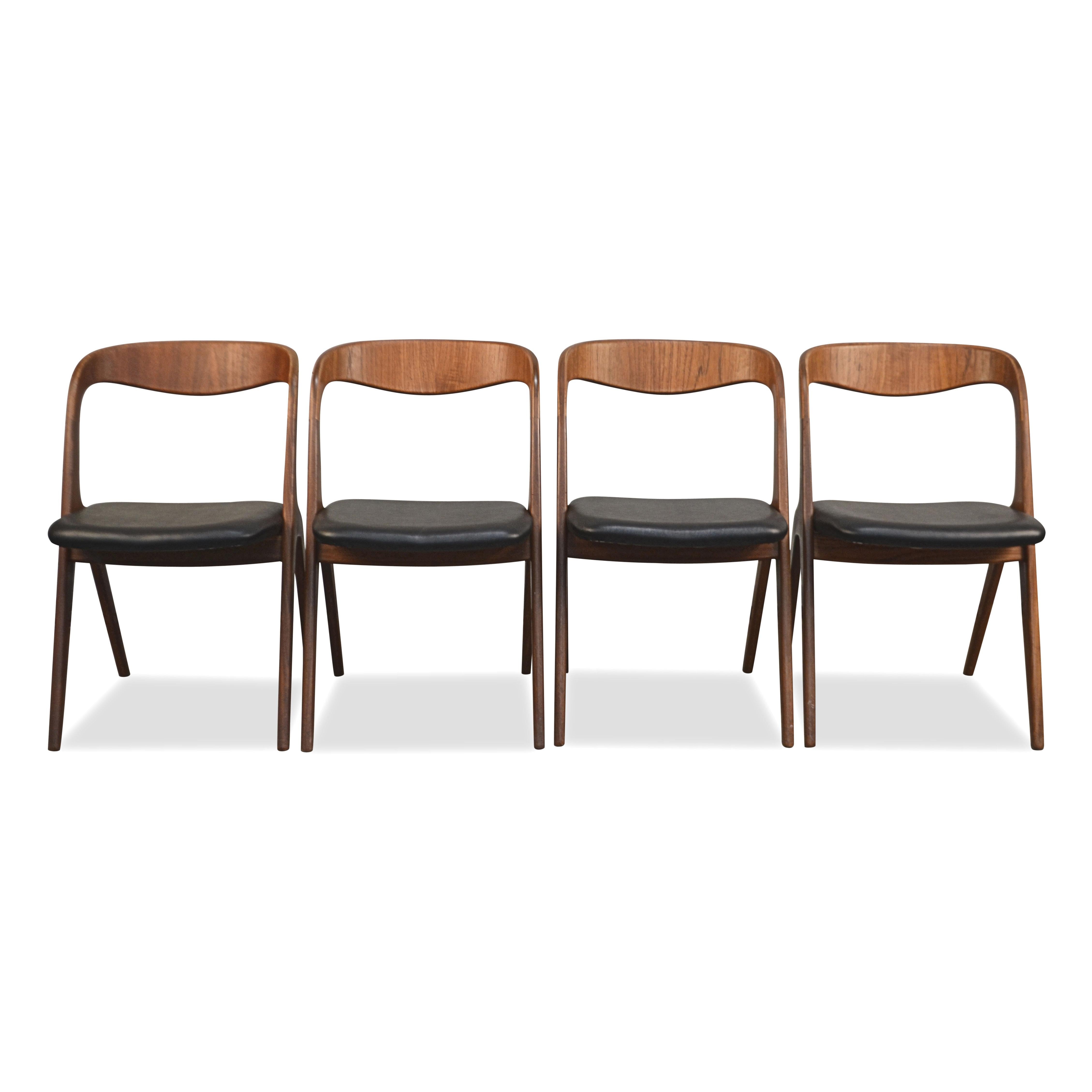 Set of four vintage dining chairs designed by Johannes Andersen manufactured by Danish manufacturer Vamo Sonderborg. These model Sonja chairs feature an organic design, with solid teak curved backrests flowing naturally into the legs. All chairs