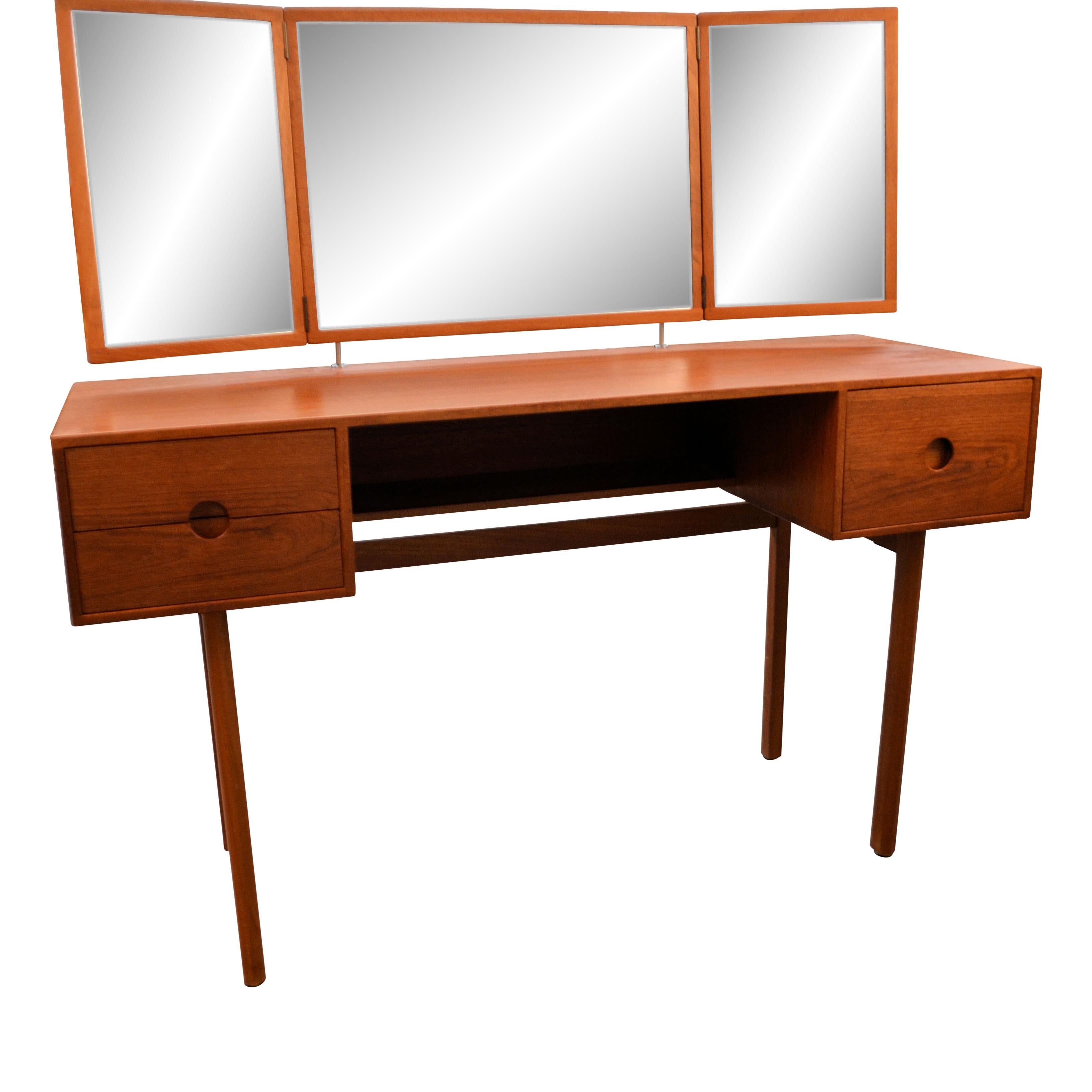 Rare Mid-century Danish dressing table designed by Kai Kristiansen for Aksel Kjersgaard. This model No. 40 vanity table features a clean, symmetrical mid-century modern design in beautiful teak wood, rectangular mirrors, and three drawers. On the