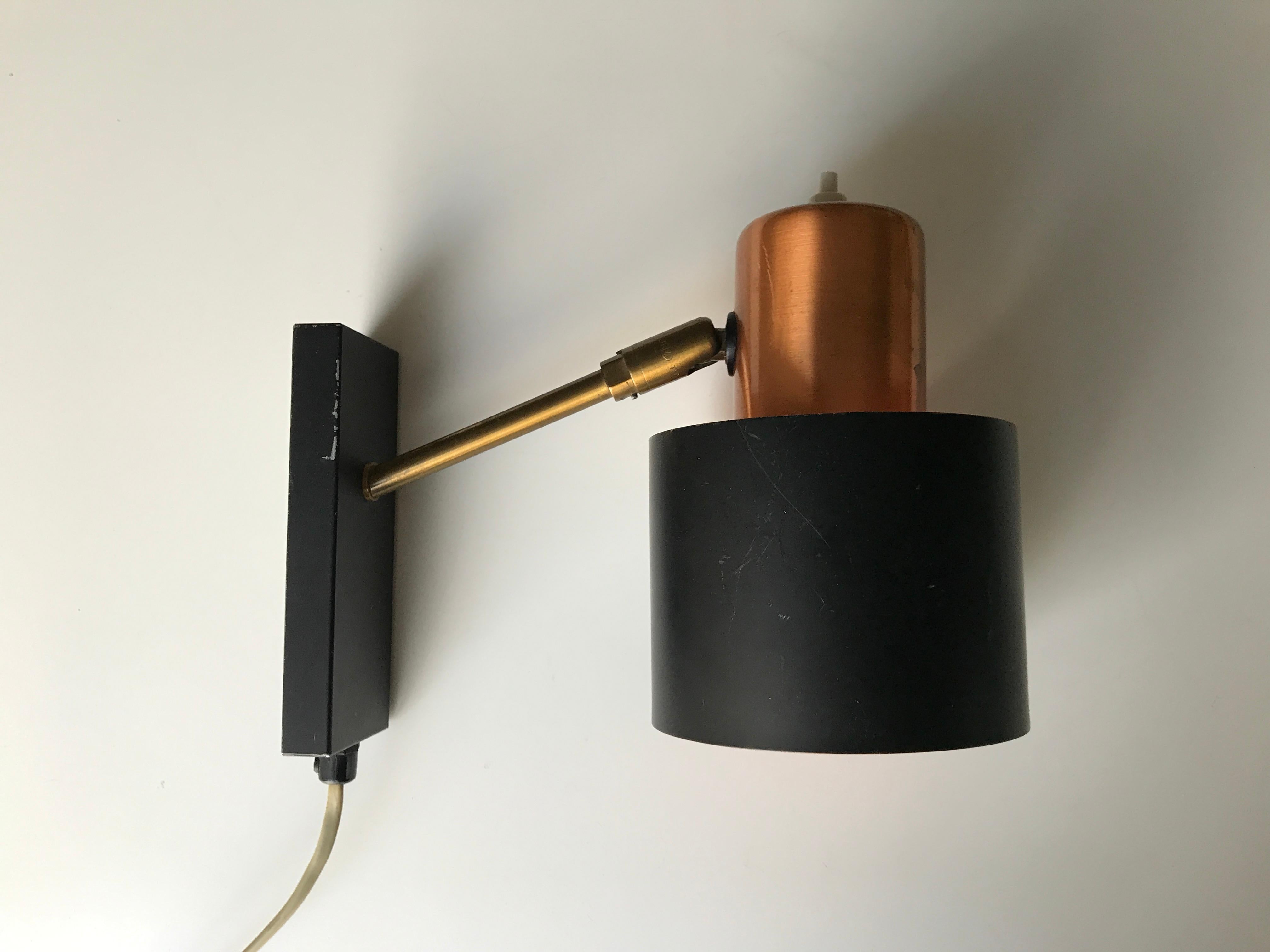 Midcentury Danish design wall light design by Jo Hammerborg. Copper and black matte surface. Typically orange surface inside shade. Manufactured by late Danish factory Lyfa. E14 bulb socket holder. Original condition. New cable can be fitted without