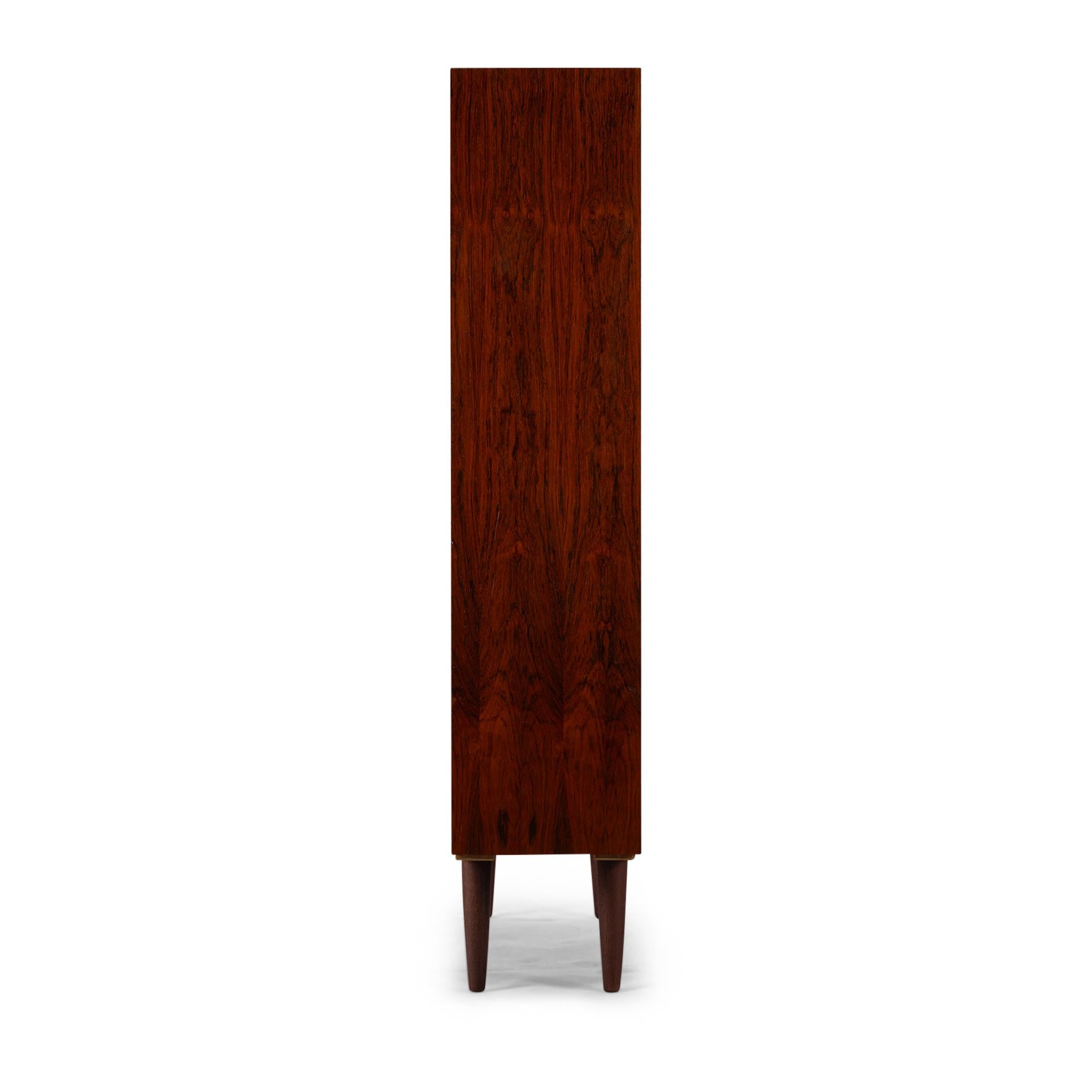 Danish Design
Introducing the Omann Jun Model 6 bookcase in rosewood. The Omann Jun Model 6 Bookcase proudly carries forward the legacy of Danish design, renowned for its clean lines, minimalist aesthetics, and exceptional craftsmanship. Inspired by