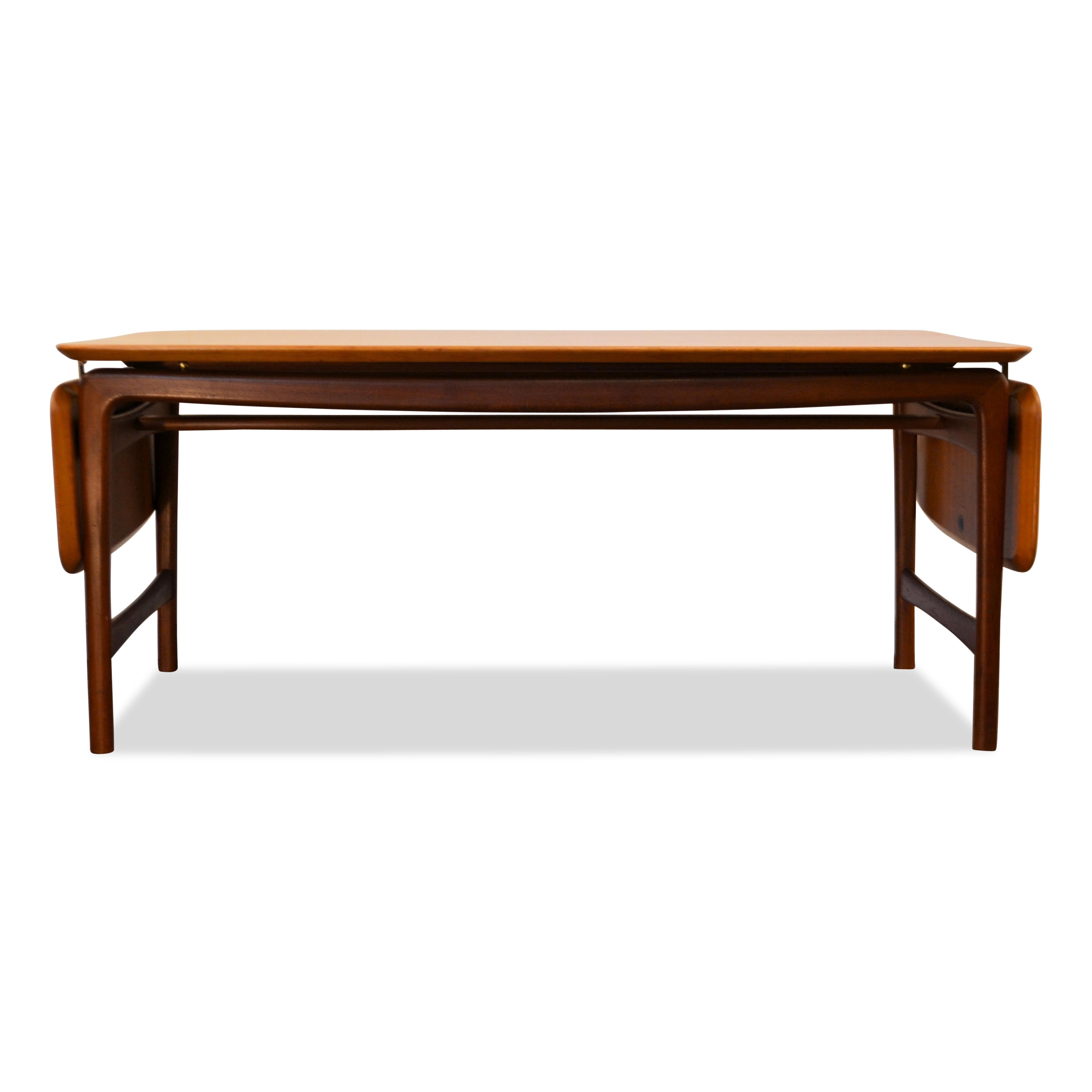 Vintage solid teak table designed by the famous Danish designer duo Peter Hvidt & Orla Mølgaard-Nielsen for France & Daverkosen. This high-end model 15/54 design table features a typical mid-century Danish design, gorgeous solid teak wood, messing