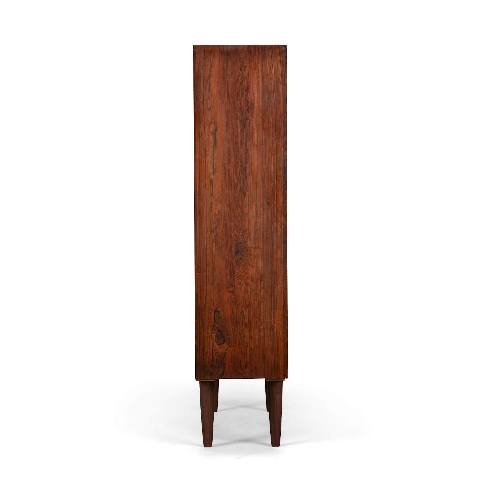 Danish tall bookcase in beautiful rosewood veneer. 
Made by Nexo. This bookcase is in very good vintage condition and has a total of 6 height-adjustable shelves.
