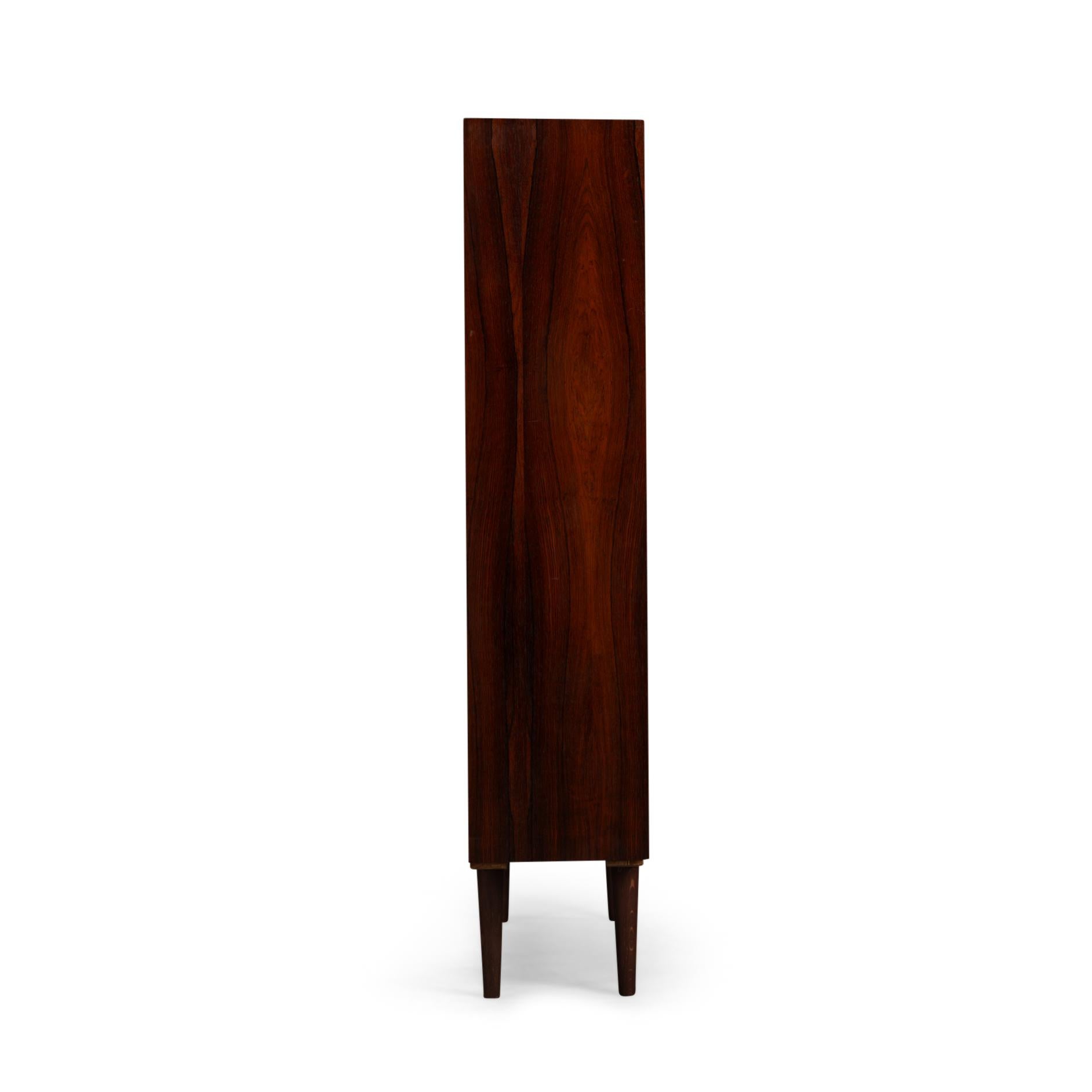 Danish Design bookcase, Model 6 in beautiful rosewood veneer by Gunni Omann for Omann Jun Mobelfabrik A/S. The brand sticker can be found on the back.

This bookcase is in very good vintage condition and has a total of 8 height-adjustable