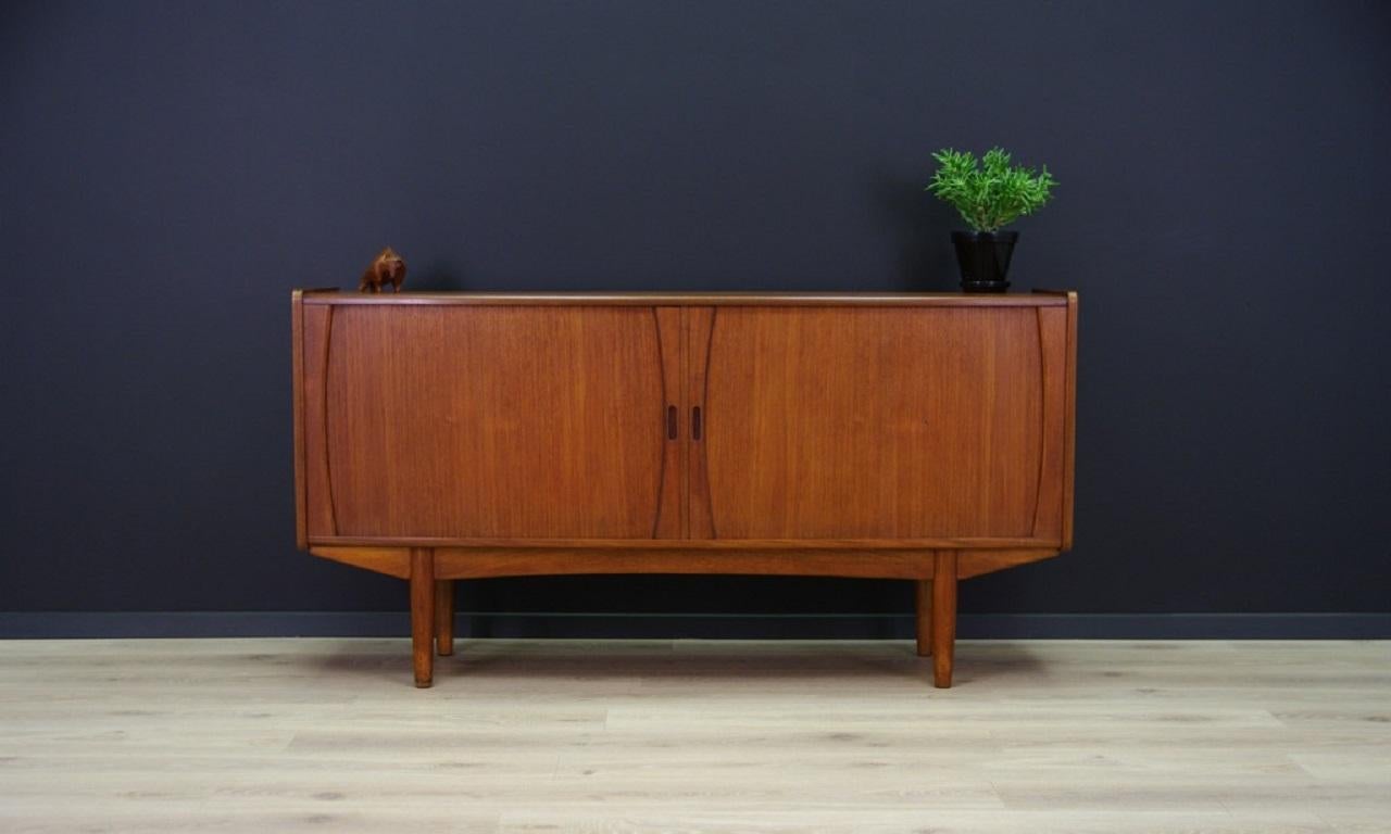 Sideboard was made in the 1960s-1970s, Danish production.

The structure is covered with teak veneer. The legs and handles are made of solid teak. The surface after refreshing. Inside the space has been filled with practical shelves. The chest of