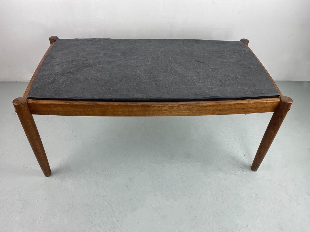 Stylish coffee table with a slate top and an oak base. Produced by Magnus Olesen, Denmark. This table is produced with a very high standard of  craftsmanship. 

Very nice detail are the wooden connecting pins in the table legs. Another beautiful
