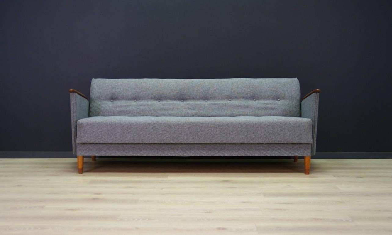 Scandinavian sofa from the 1960s-1970s, Danish design, Minimalist form with the possibility of sleeping arrangements. Phenomenal teak armrests, upholstery after replacing - gray. Preserved in good condition (minor scratches and dings on wooden