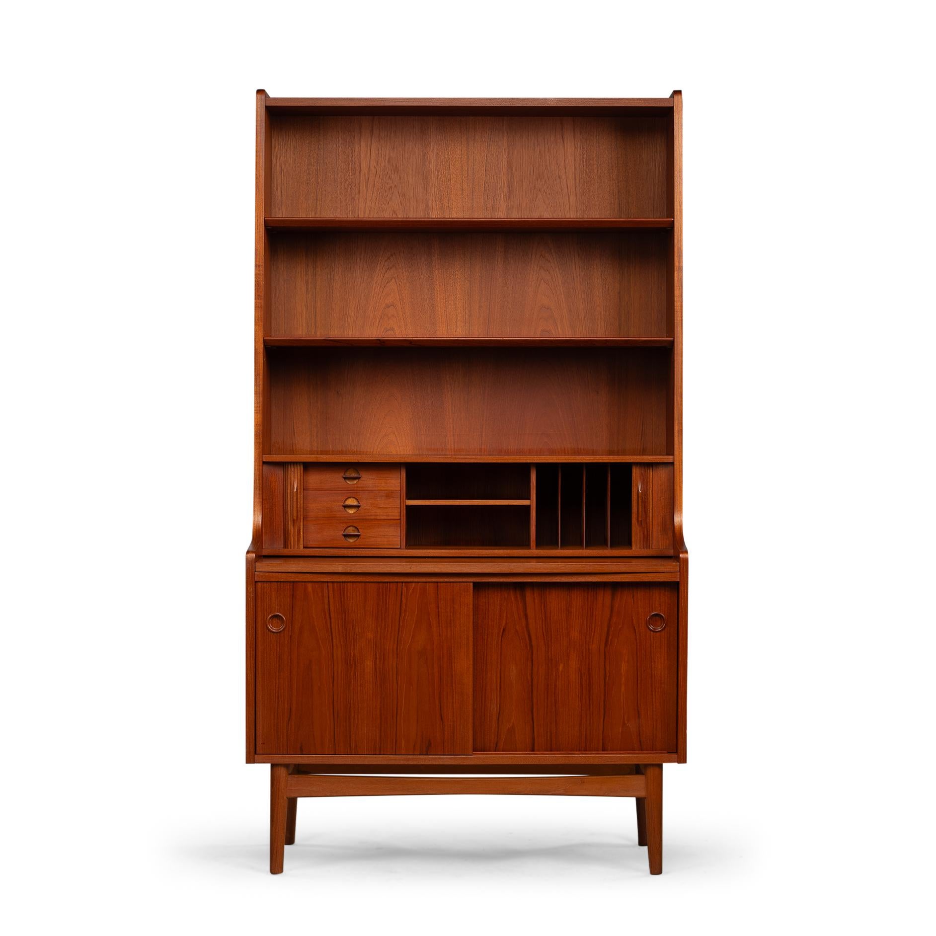 Danish Design Secretaire
This tall Danish chest of shelves with pull out desk is manufactured Bornholms Møbelfabrik  from a pressed wood teak veneer composite. Made late 60s the design by Johannes Sorth of this chest of shelves was aimed for city