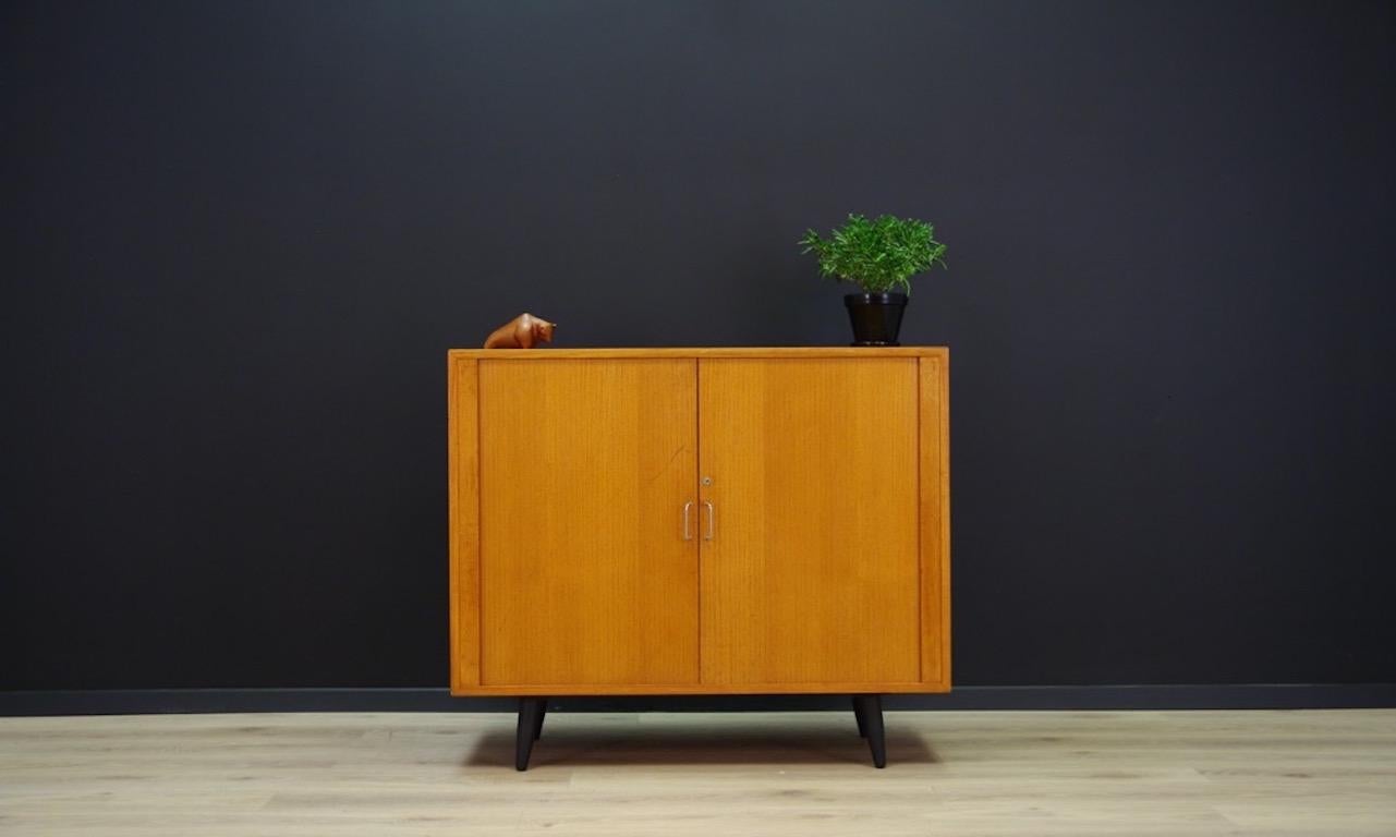 Fantastic cabinet from the 1960s - minimalistic form - Danish design. A spacious interior with a shelf behind the doors, form veneered with teak. No key in set. Preserved in good condition (small bruises and scratches) - directly for