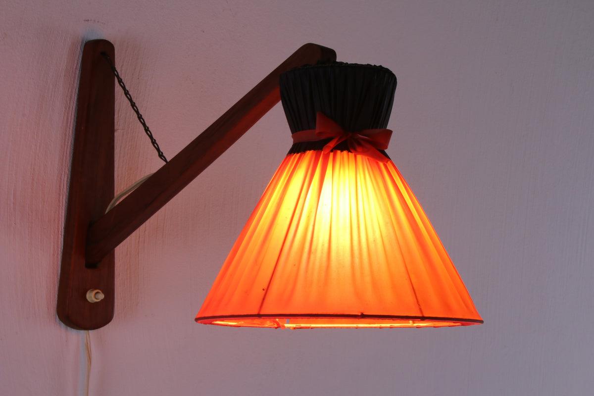 Danish Design Wall Lamp With Original Shade, 1960s

Beautiful vintage wall lamp originally from Denmark made of teak wood and fabric shade.

Can be mounted on the wall, the arm is also attached with a beautiful original chain.

This lamp was made in