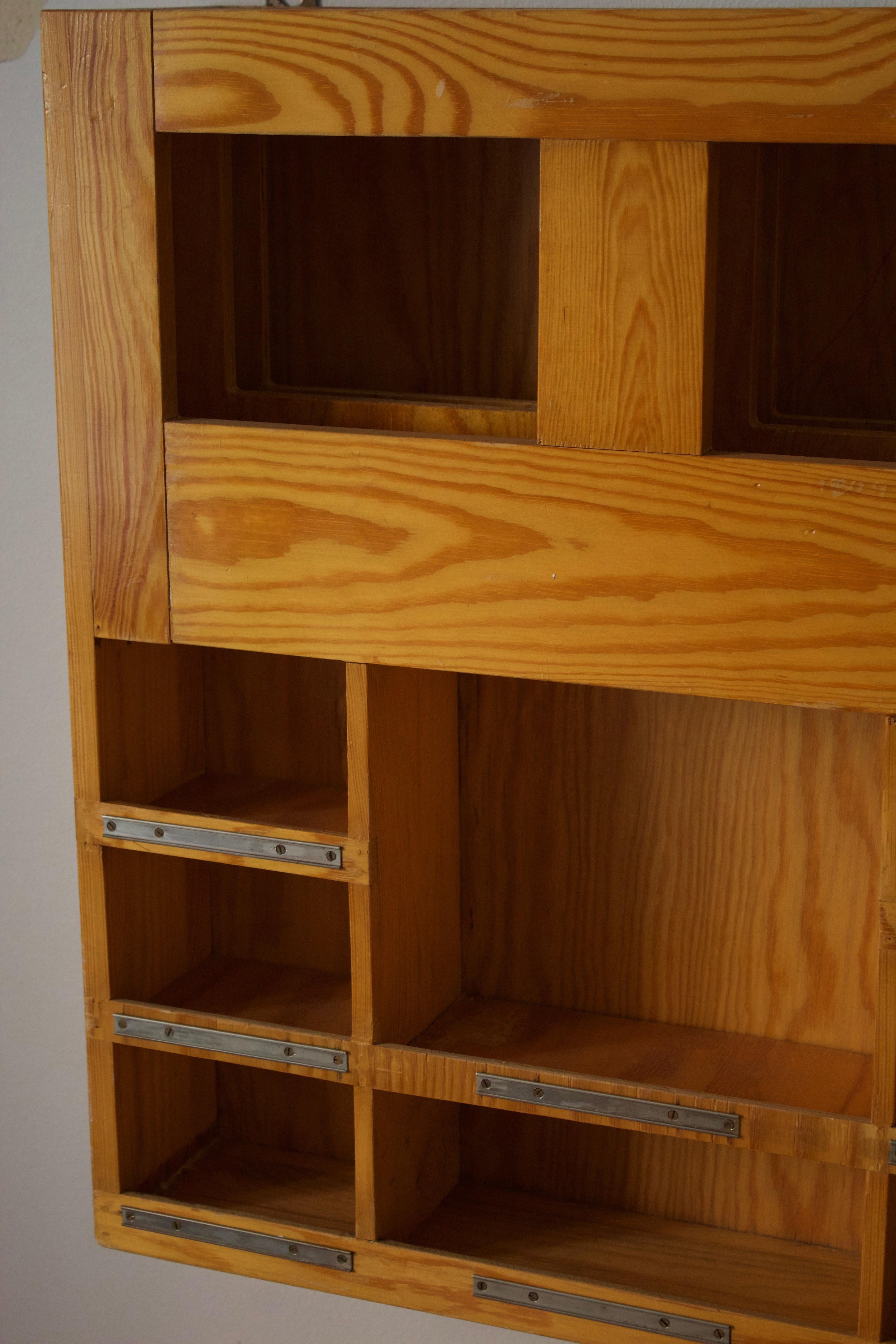 A wall mounted magazine rack with shelves. Features display shelves and magazine storage.
  
  