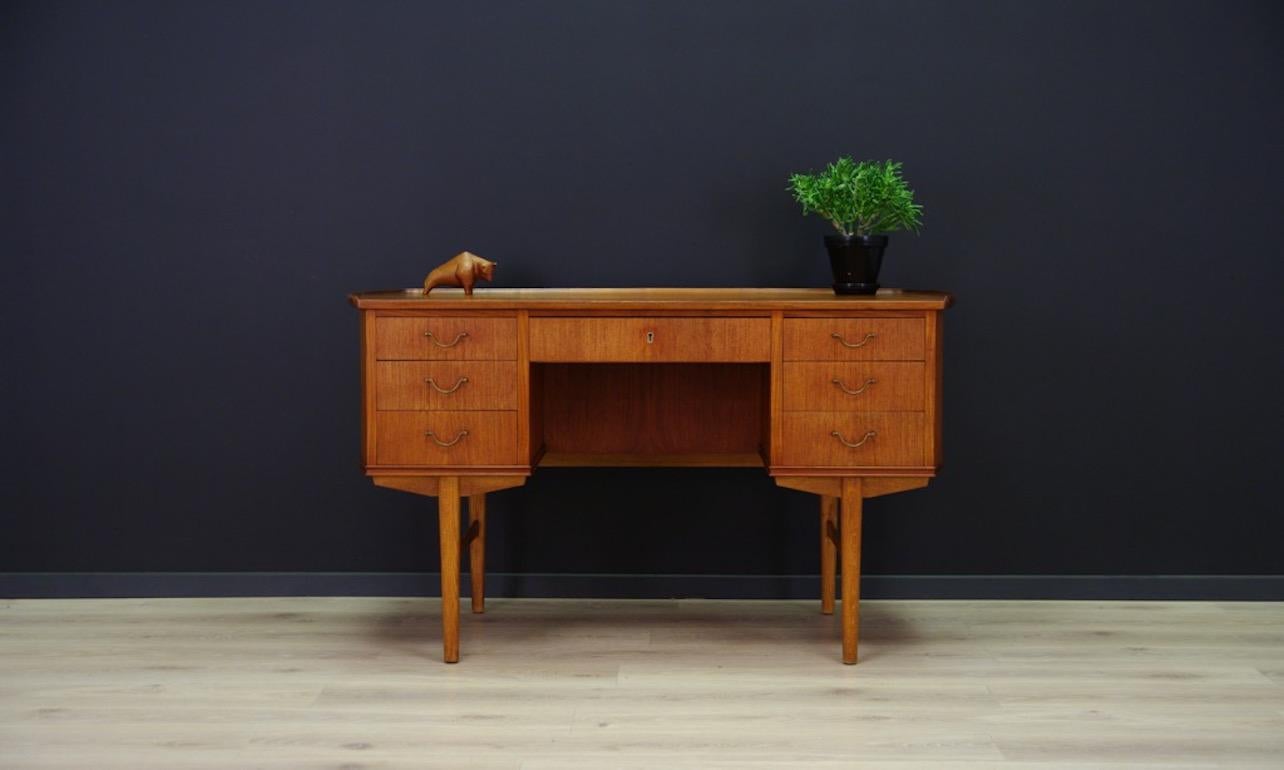 Fantastic desk from the 1960s-1970s, minimalistic Danish design, perfect in every detail. Form veneered with teak. It has seven capacious drawers and a book shelf at the back. Preserved in good condition (small dings and scratches, no key) -