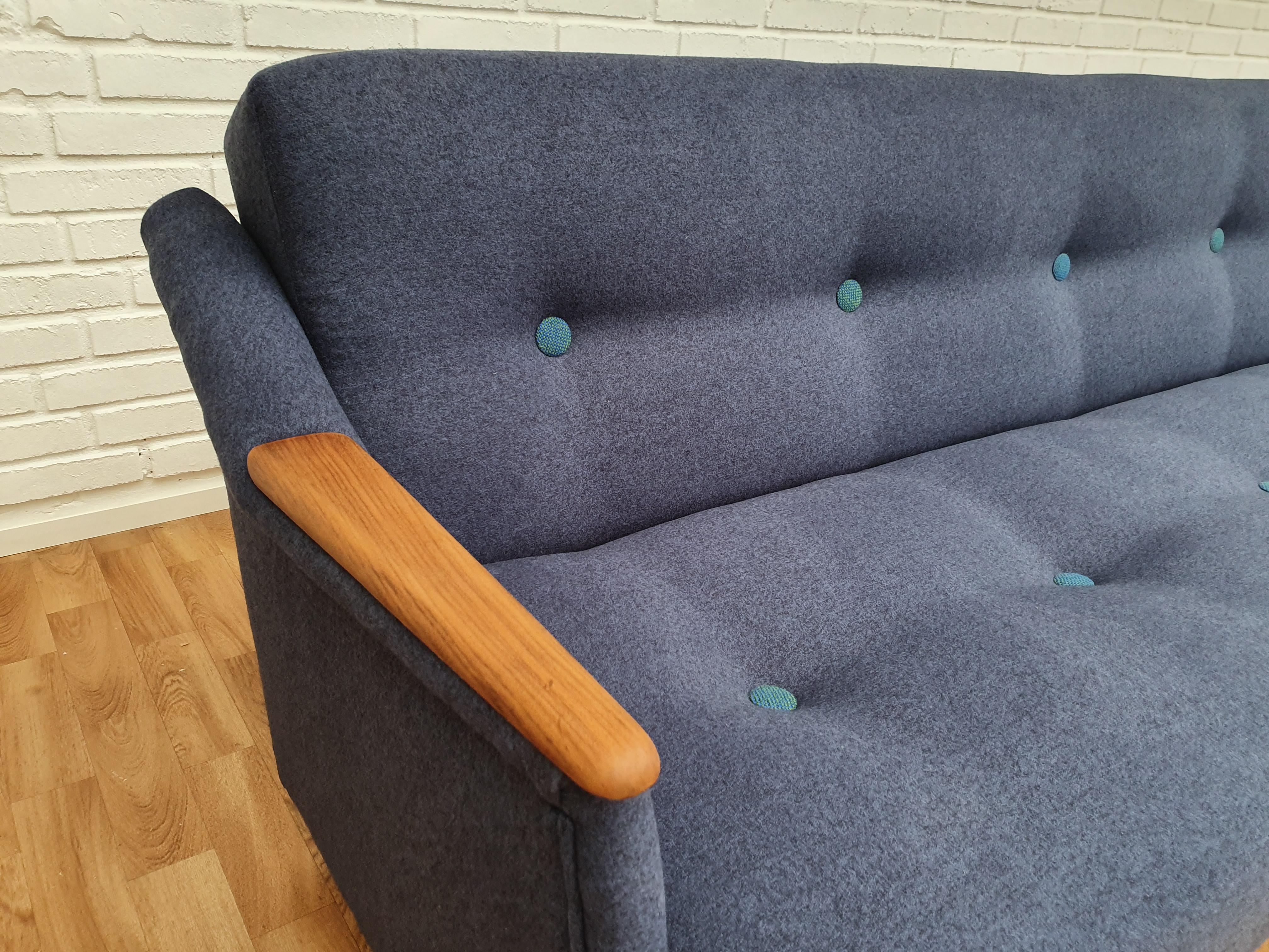 Danish designed very nice 3 persons sofa bed. Teak nails and stained beech legs. Manufactured in about 1960 by Danish Furniture Manufacturer. Original springs. Completely renovated in quality blue upholstery fabric by furniture craftsmen at Retro