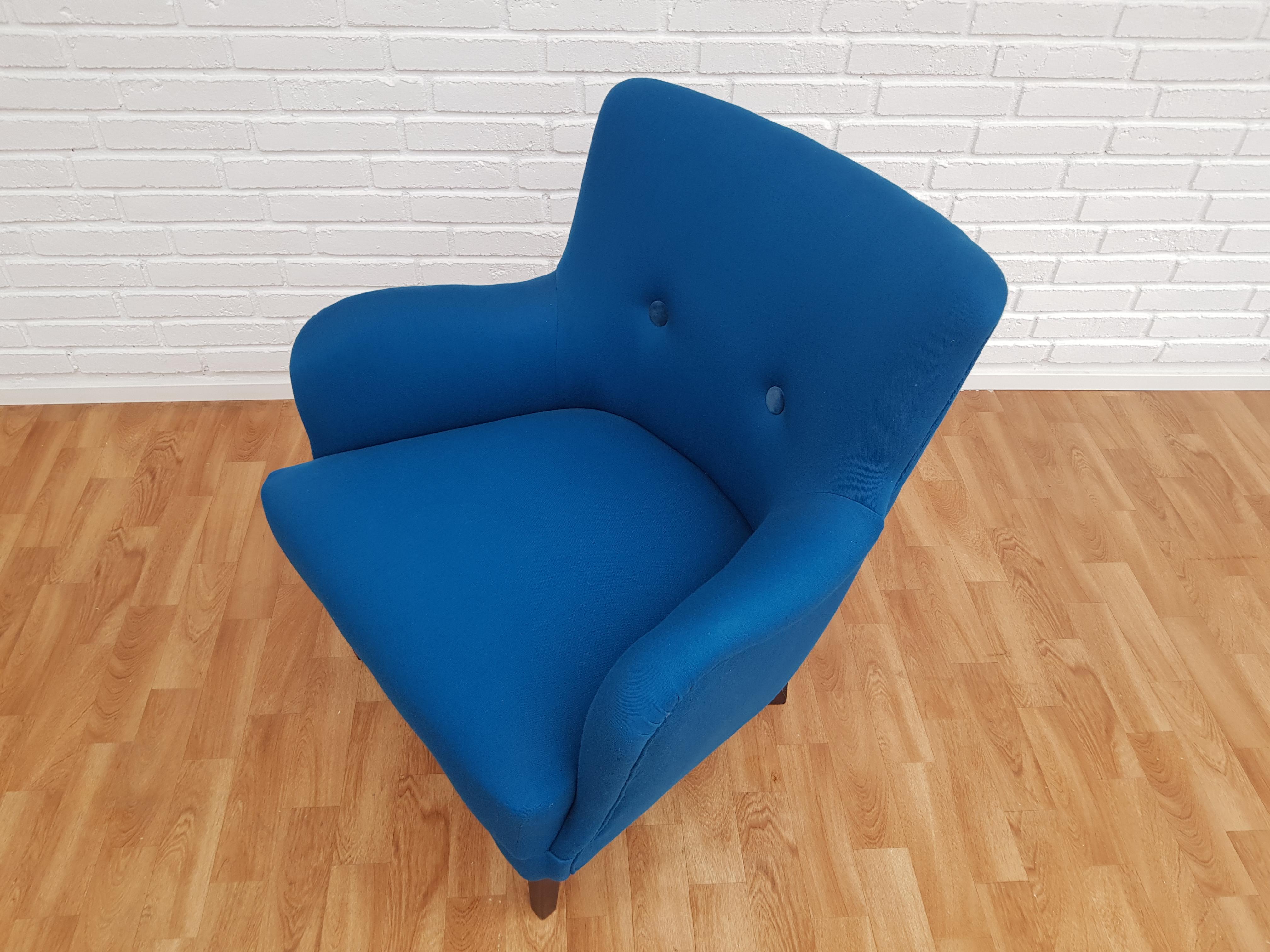 Danish armchair. New reupholstered in quality turquoise blue wool fabric by professional furniture upholsterer at Retro Møbler Galleri. Velour buttons. Made by Danish furniture manufacturer circa 1970. The seat with original 