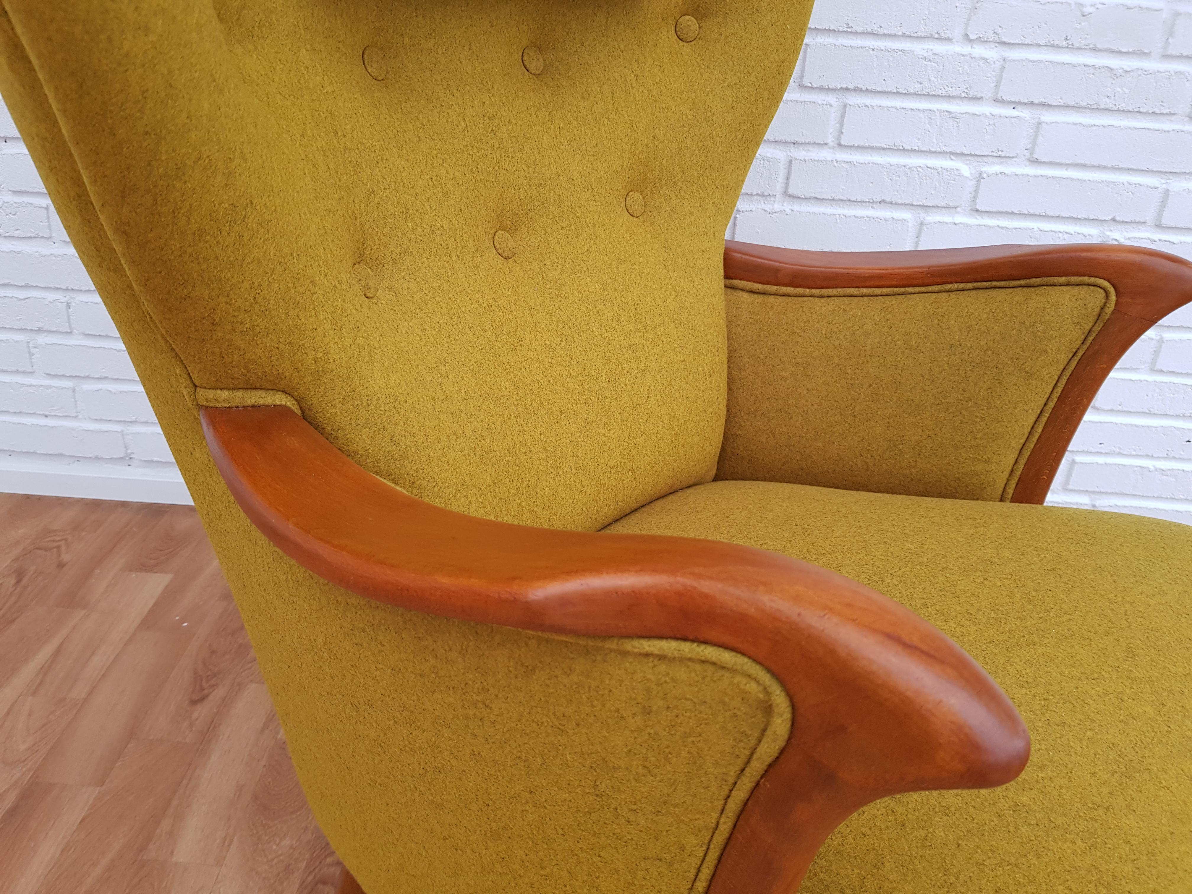 A nice Danish design reading chair, wool fabric, ottoman, neck pillow. Danish furniture manufacturer. Produced in circa 1960s. New reupholstered in quality curry-yellow wool fabric. Completely renovated (new foam, felt, cotton) by professional