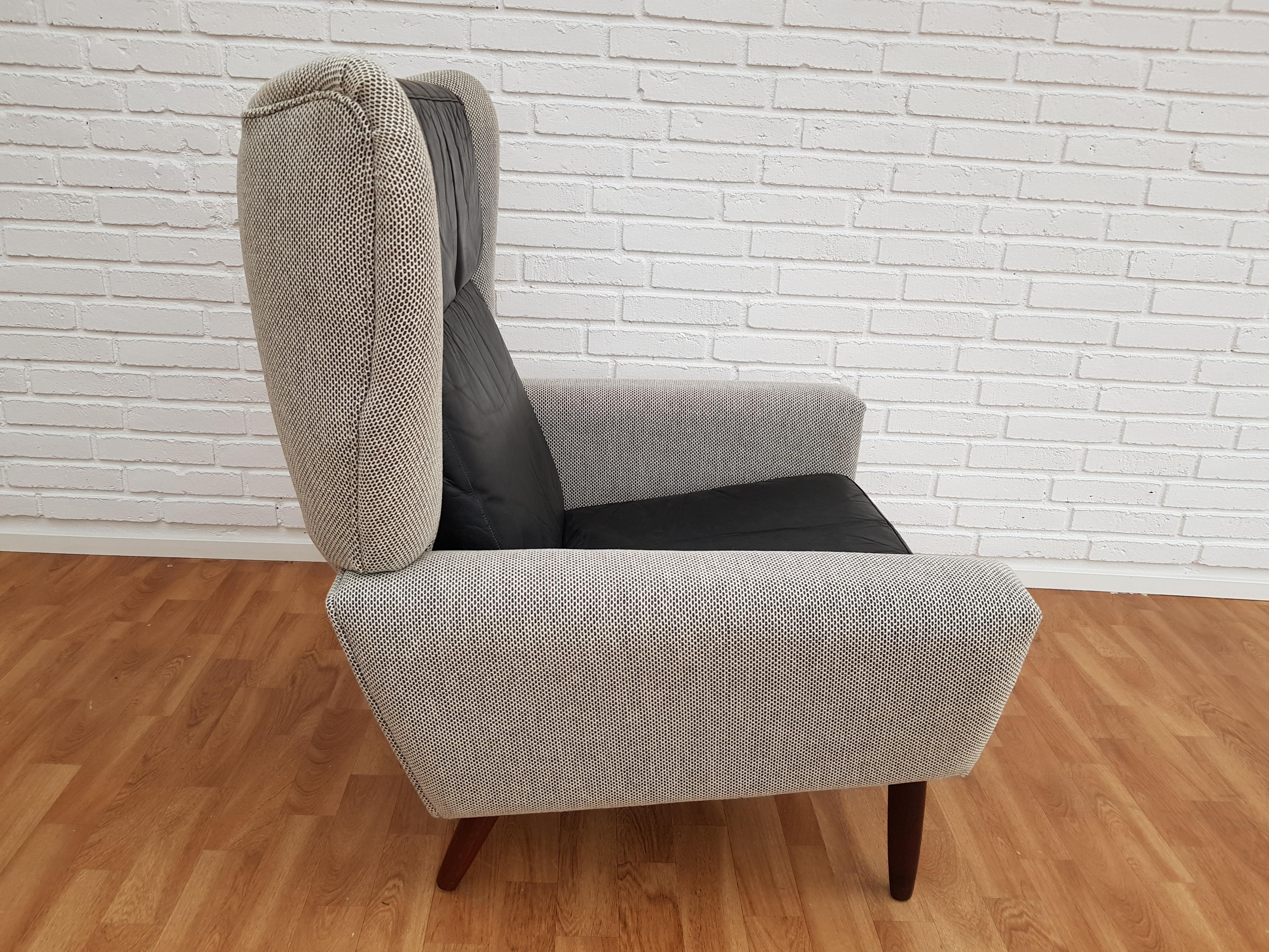 A unique cool armchair with loose cushions. Made in circa 1970 by Danish furniture manufacturer. Teakwood legs. Completely renovated by craftsman, furniture upholsterer at Retro Møbler Galleri. New reupholstered in quality light gray or white wool