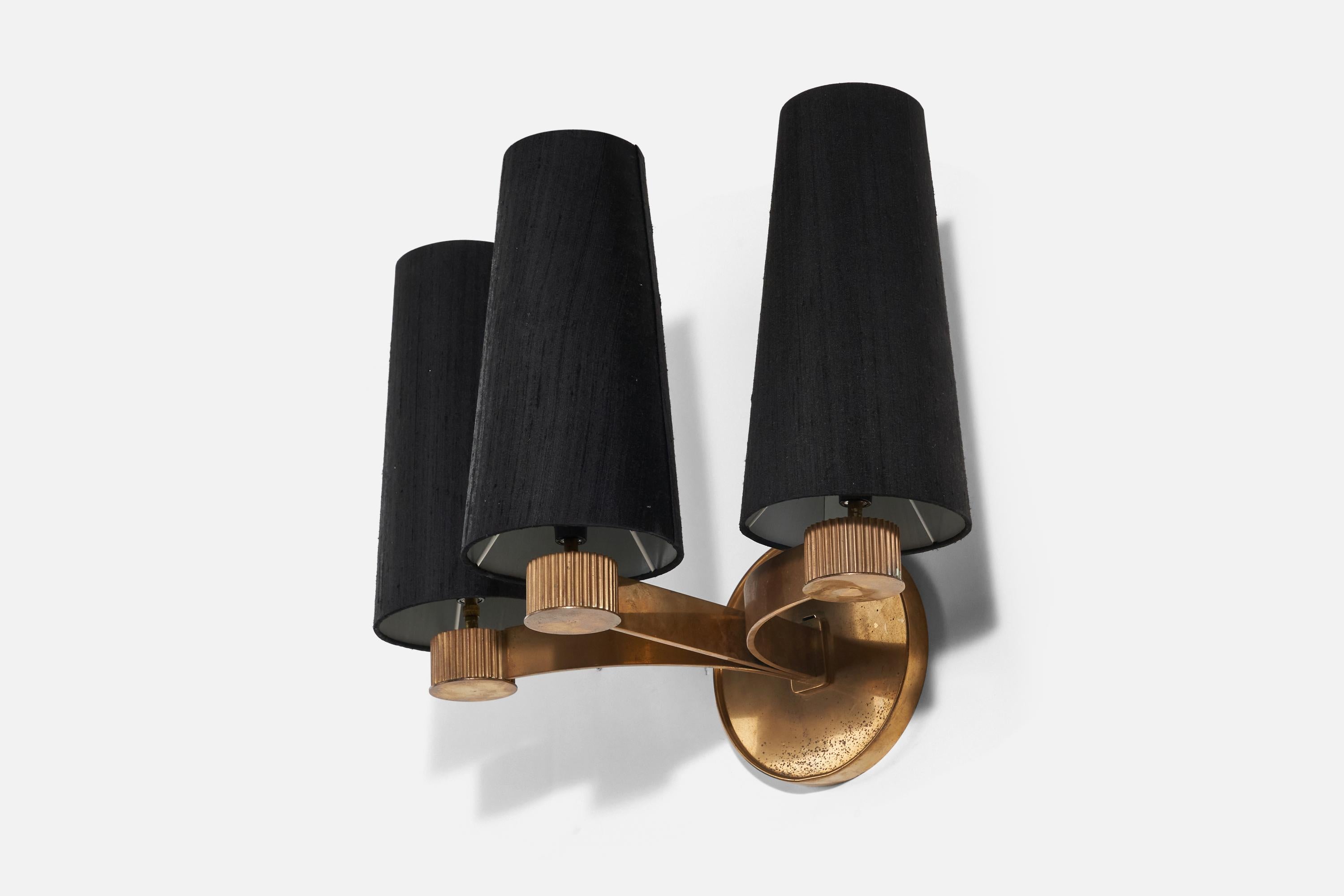 A brass black fabric 3-light sconce / wall light designed and produced in Denmark, 1940s.

Sold with Lampshades. Dimensions stated are of Sconce with Lampshades.

Socket takes Euro base E-12 bulb.

There is no maximum wattage stated on the