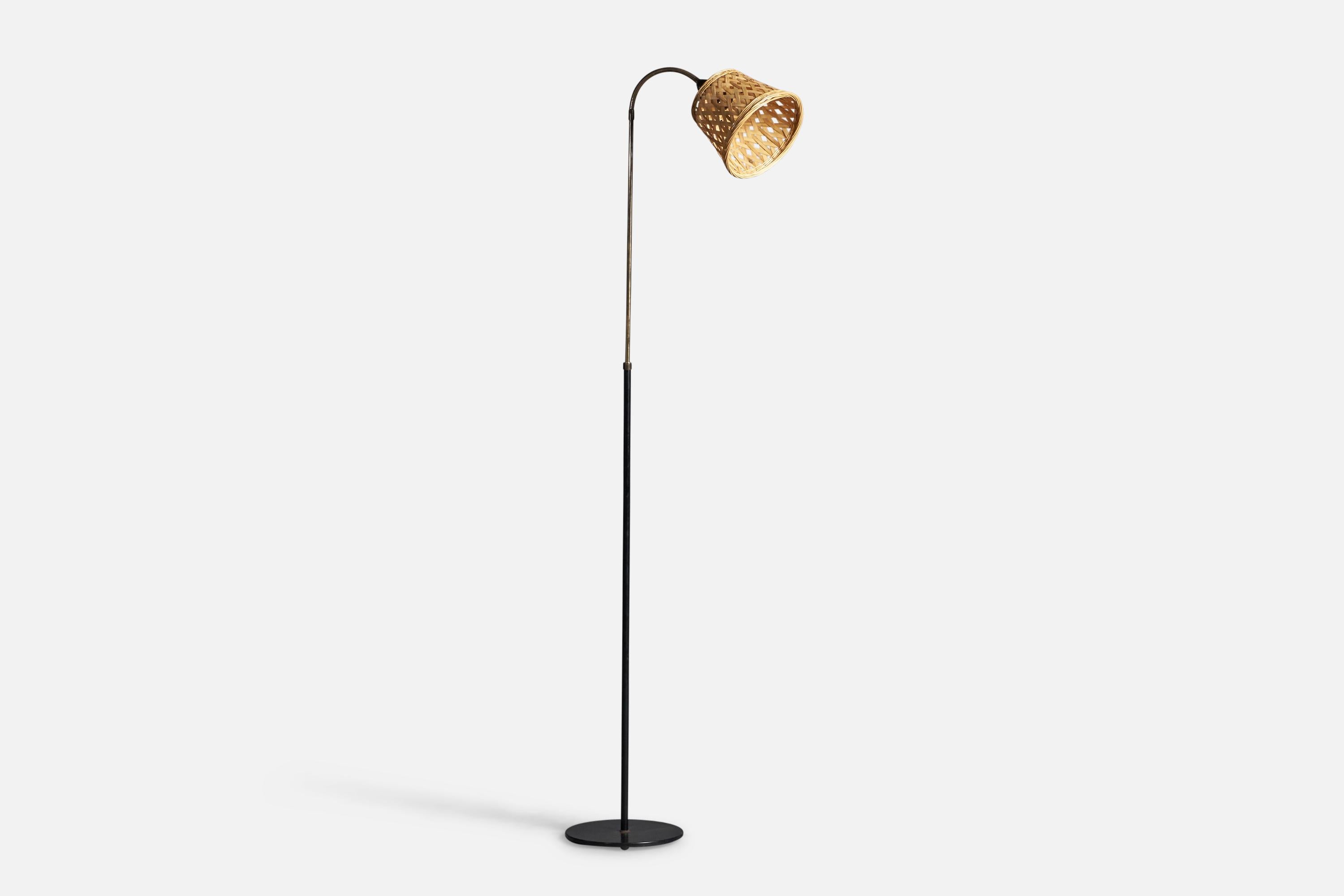 An adjustable brass, rattan and black-lacquered metal floor lamp, designed and produced in Denmark, c. 1950s.

Overall Dimensions: 60.25