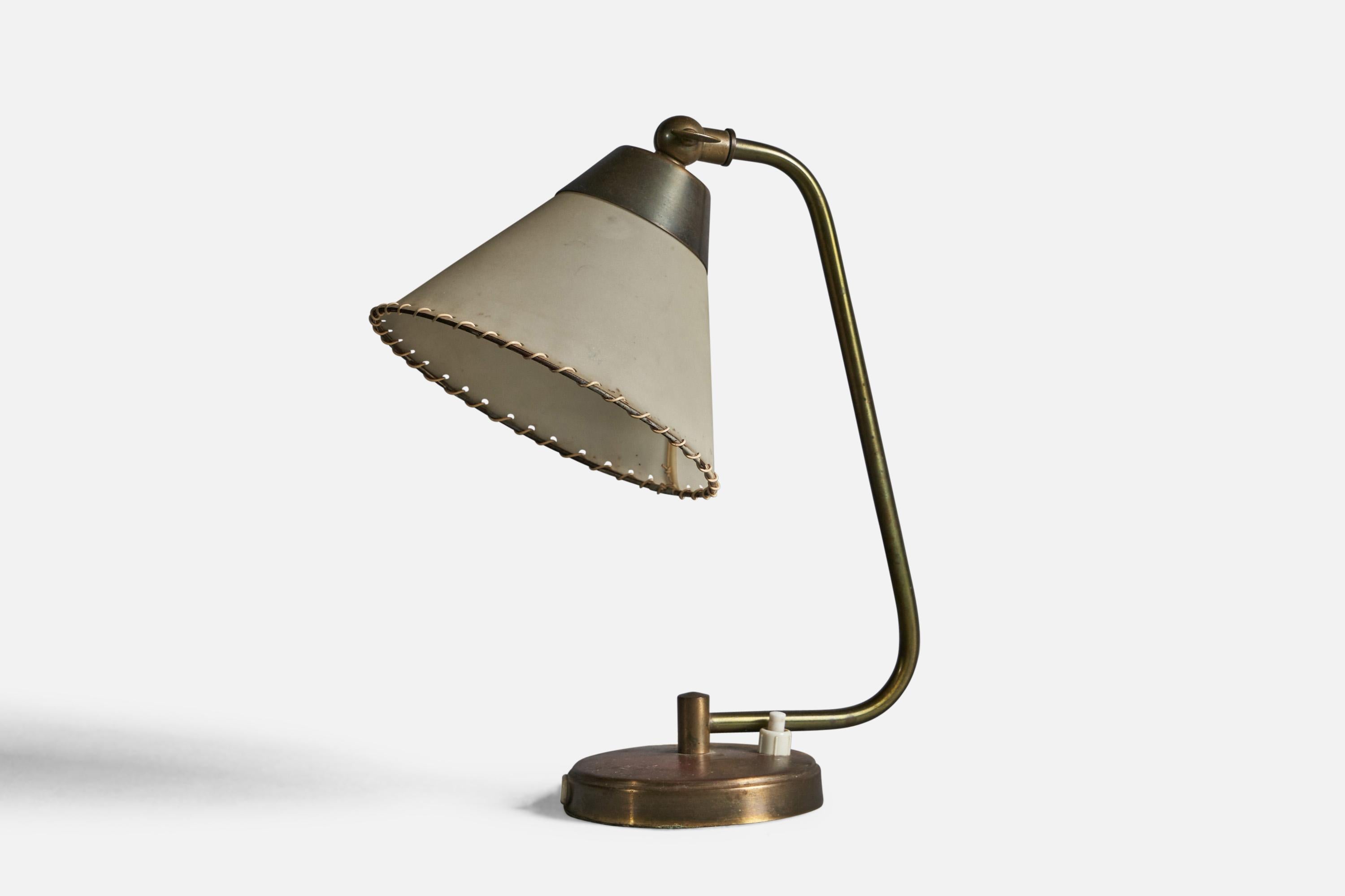 An adjustable brass and parchment paper table lamp designed and produced in Denmark, 1940s.

Overall Dimensions (inches): 10