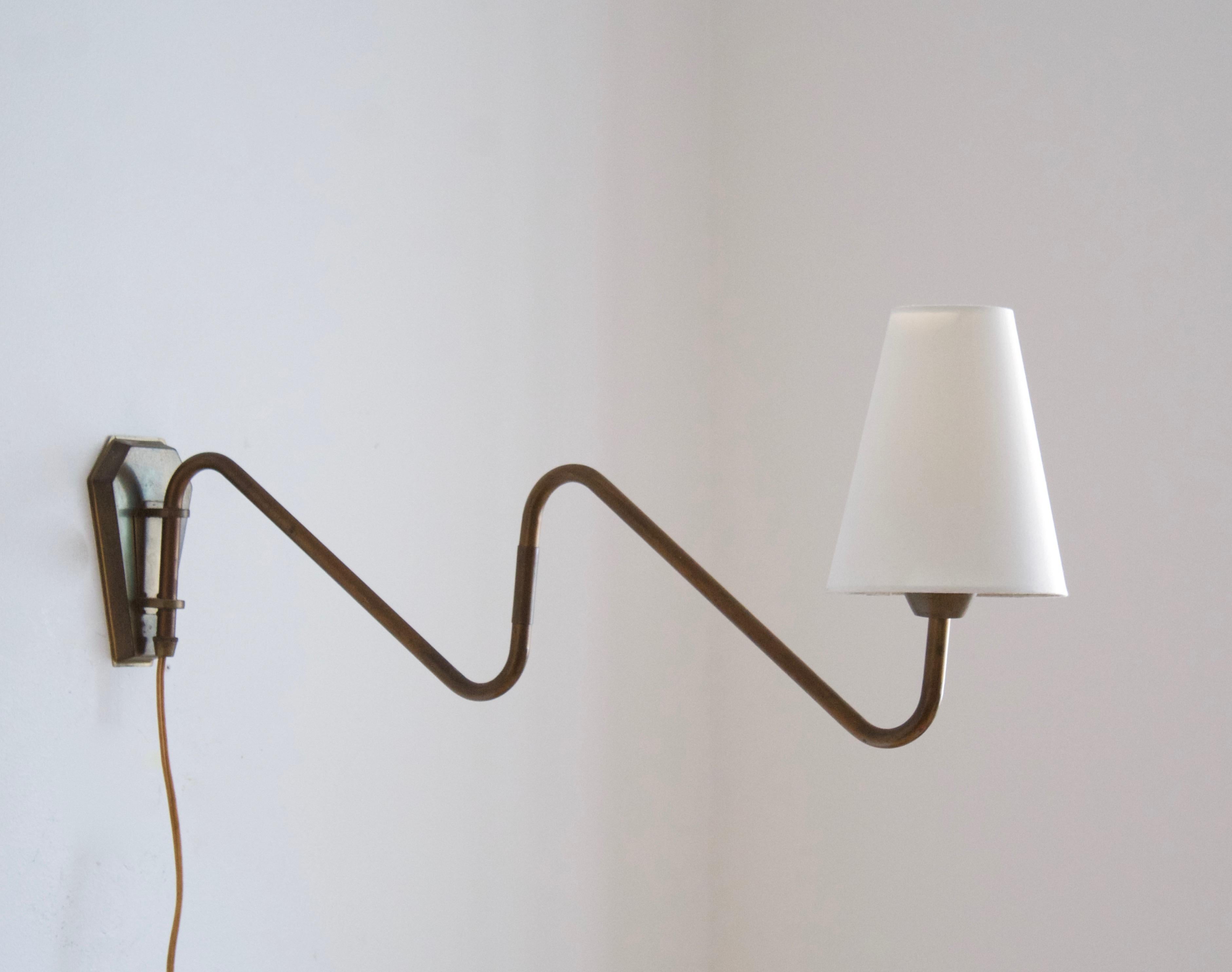 A functionalist wall light / task light, designed and produced in Denmark, 1940s. Features brass. Brand new lampshade.

Stated dimensions with lampshade attached as is illustrated in the primary image.