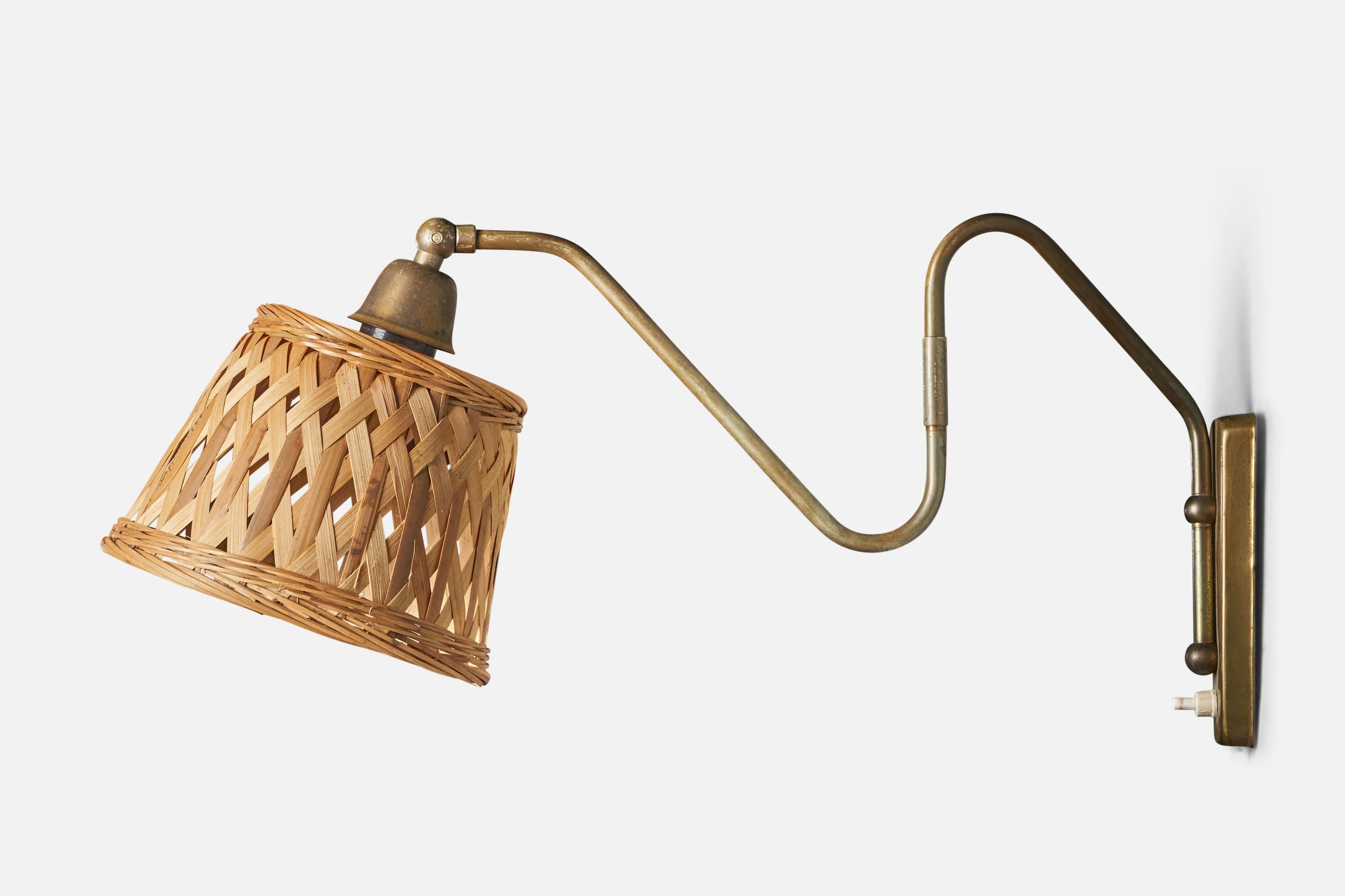 An adjustable brass and rattan wall light, designed and produced in Denmark, 1940s.

Overall Dimensions (inches): 9