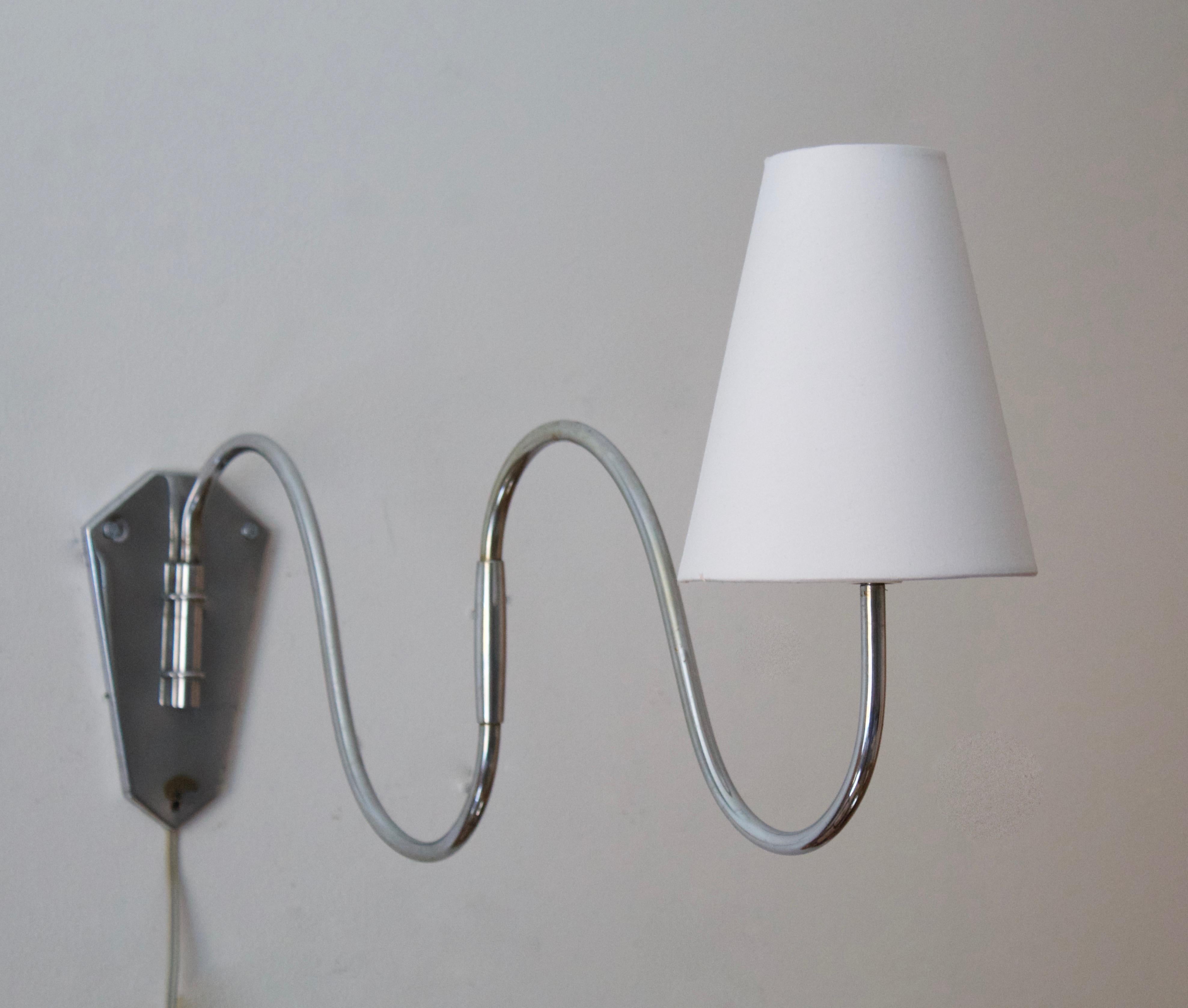 A functionalist wall light / task light, designed and produced in Denmark, 1940s. Features chrome steel. Brand new lampshade.

Stated dimensions with lampshade attached as is illustrated in the primary image.