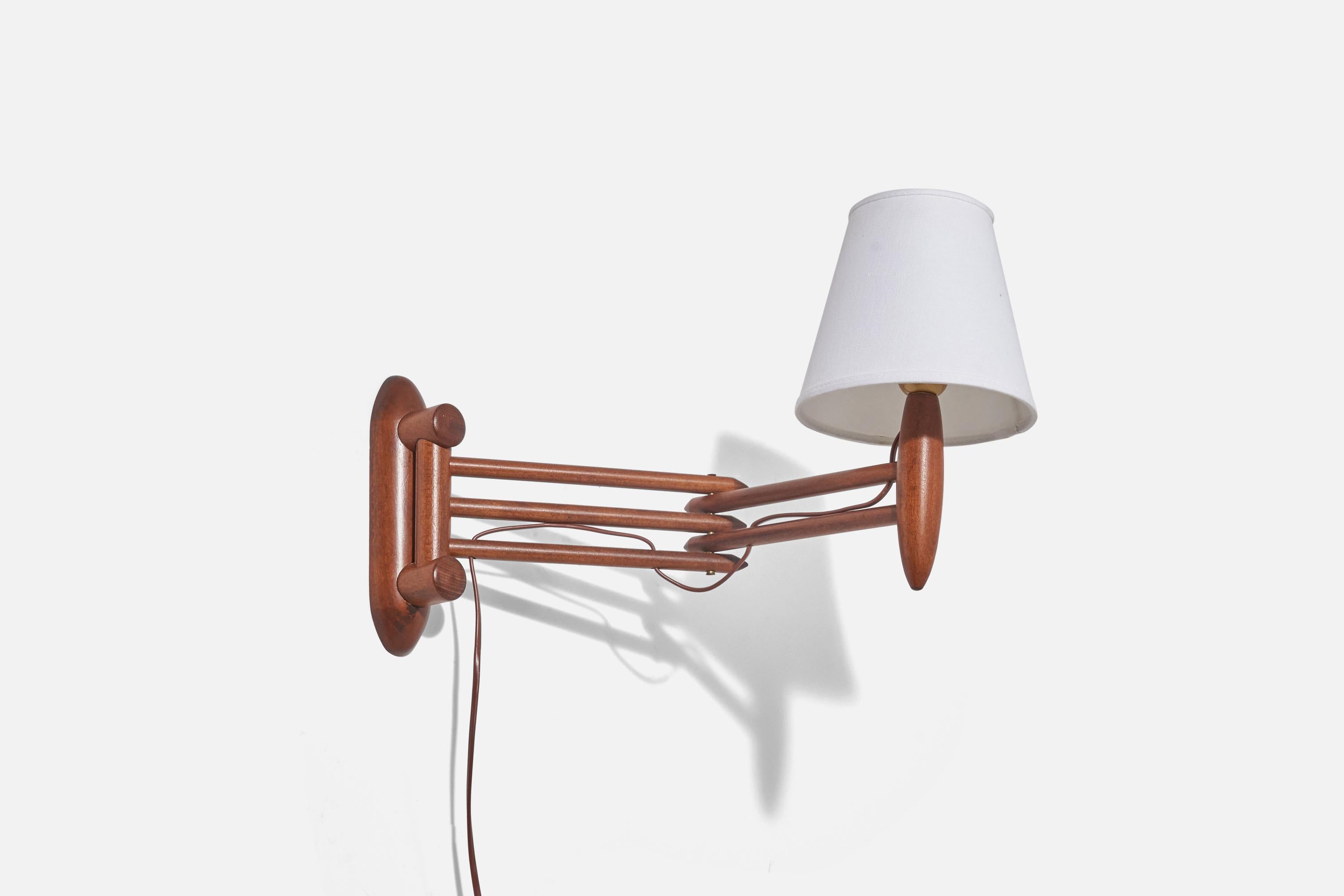 A teak and fabric, adjustable wall light designed and produced in Denmark, 1960s.

 Sold with Lampshade(s). Dimensions stated are of Sconce with Shade(s).

Dimensions variable, measurements listed are at the maximum extended position. 

Socket