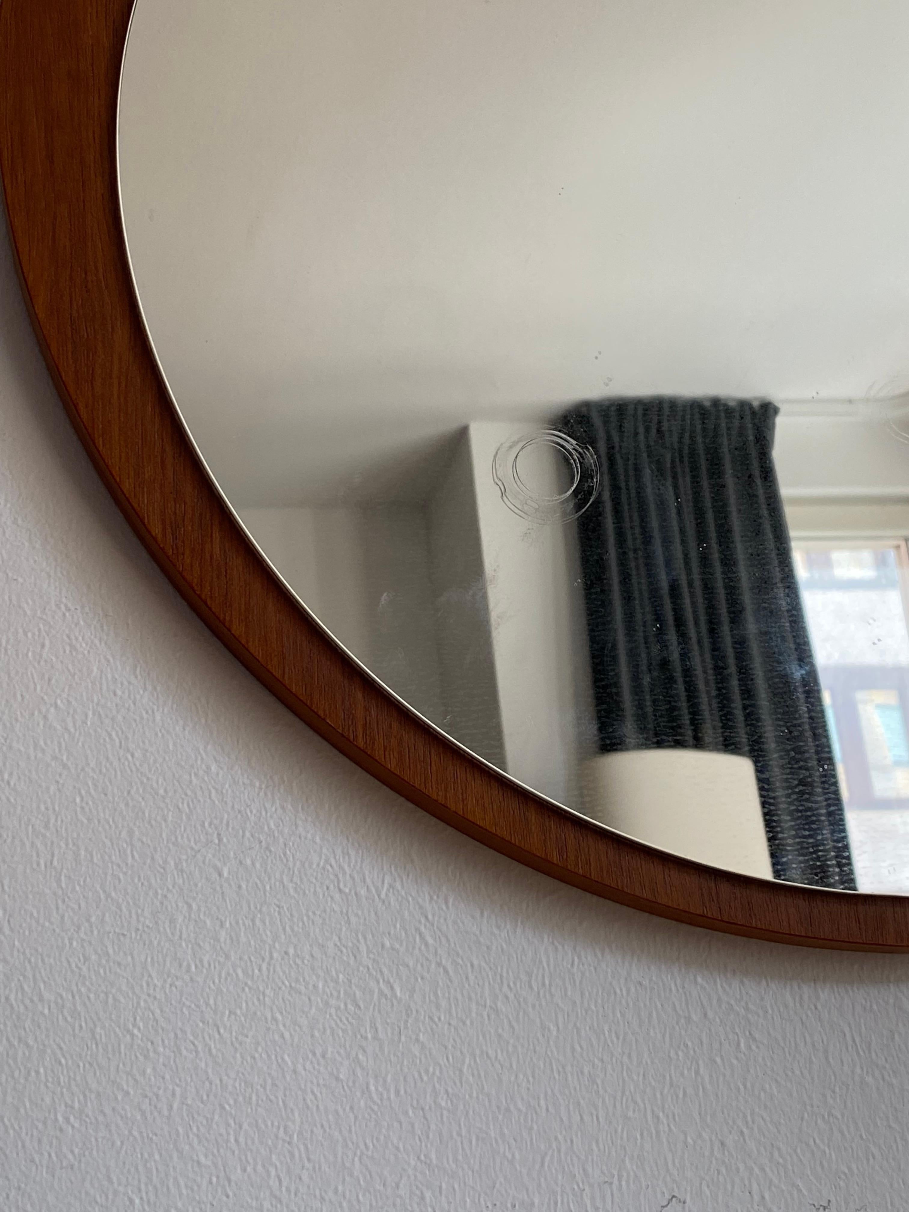 An assymetric wall mirror. Designed and produced in Denmark, 1960s.

     