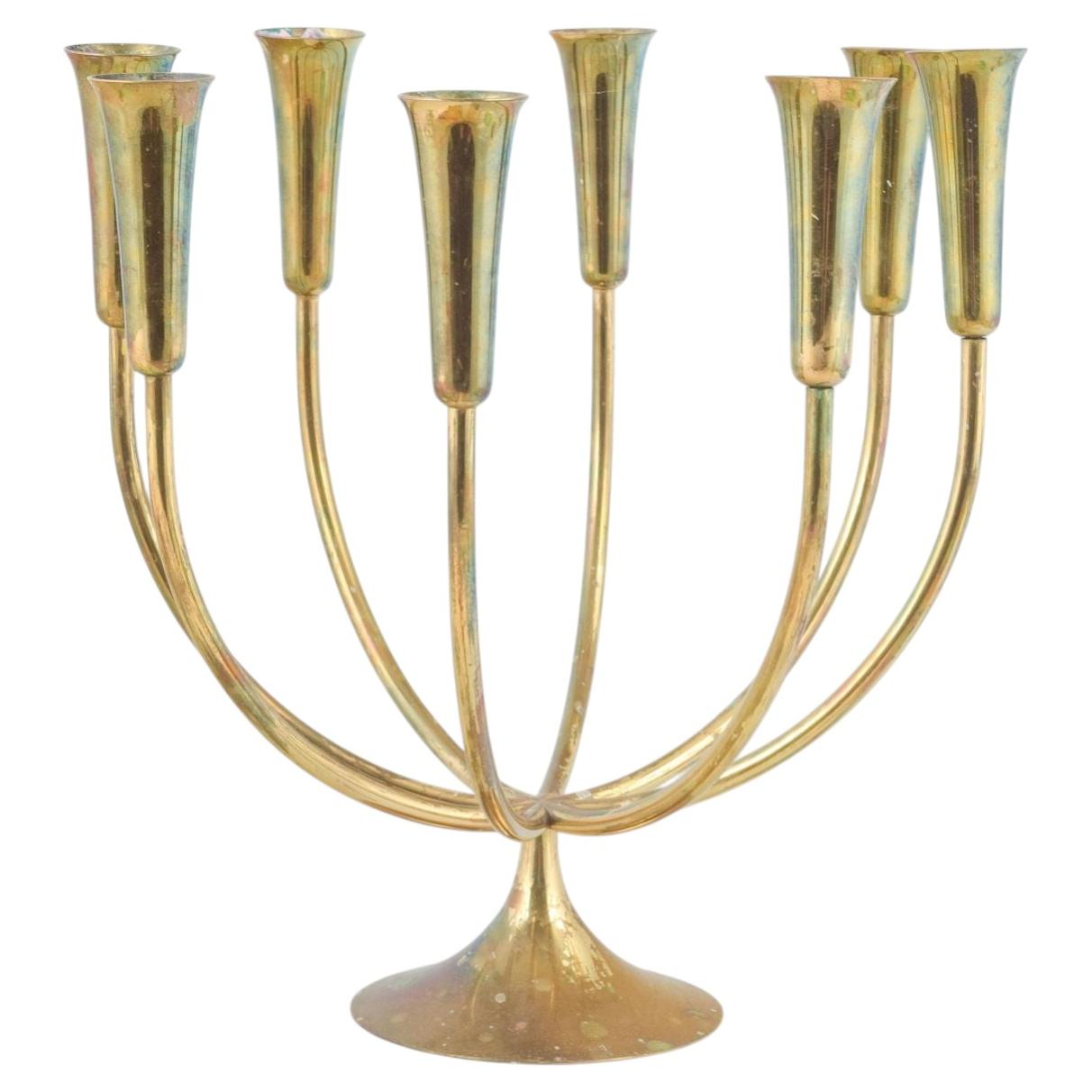 Danish designer. Brass candelabrum with eight curved arms. 1970s