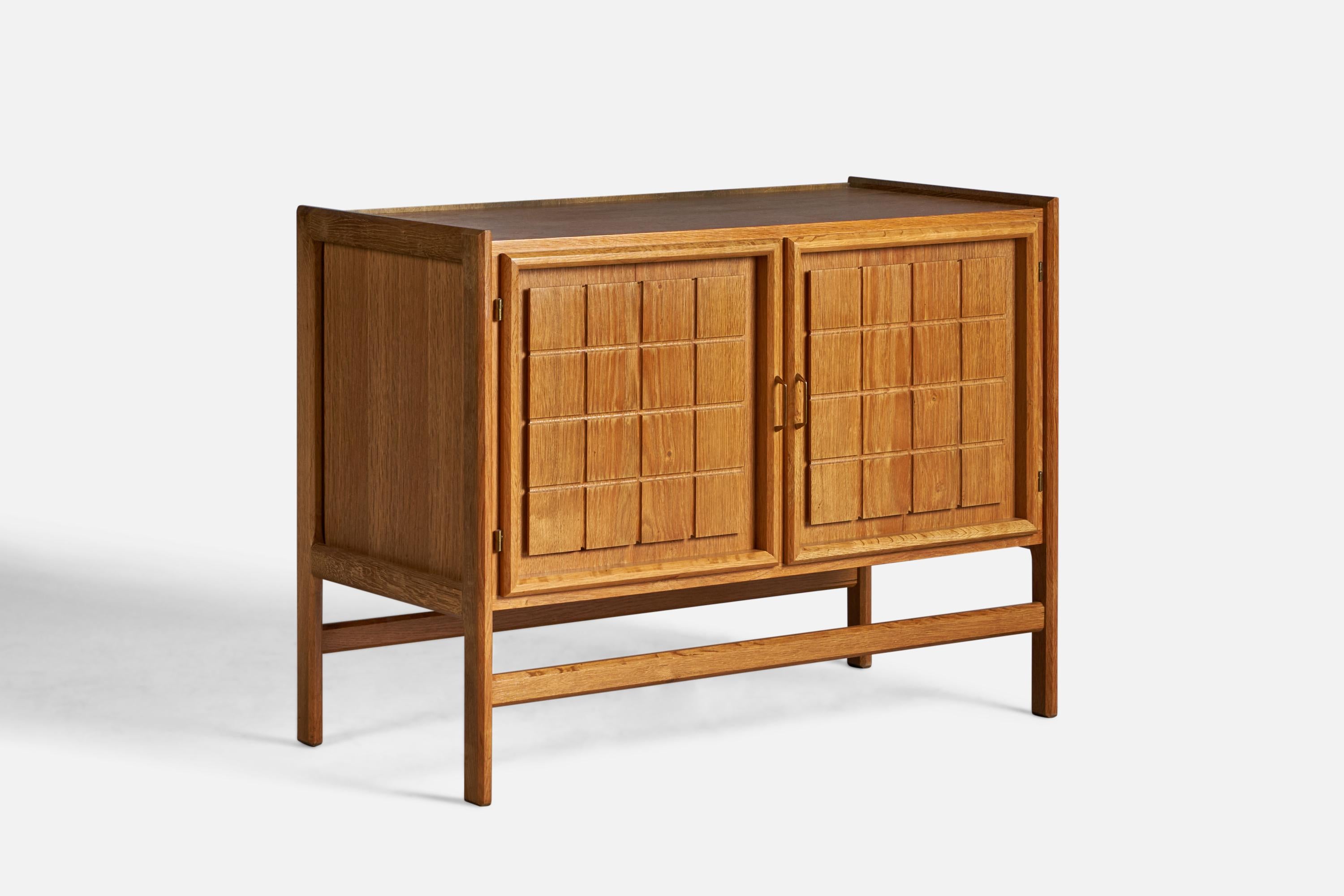 An oak and brass cabinet, designed and produced in Denmark, 1950s.