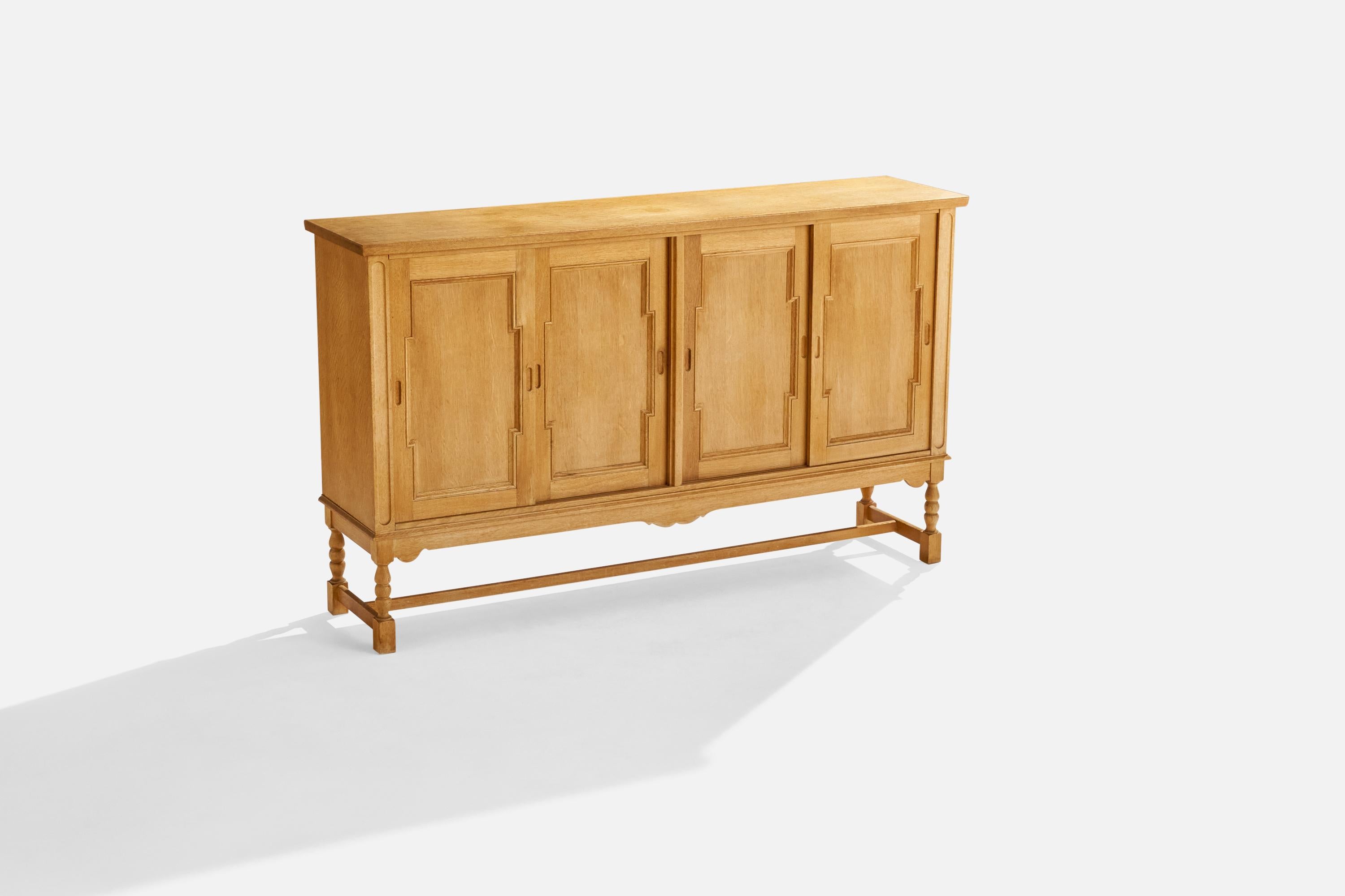 An oak cabinet designed and produced in Denmark, c. 1960s.