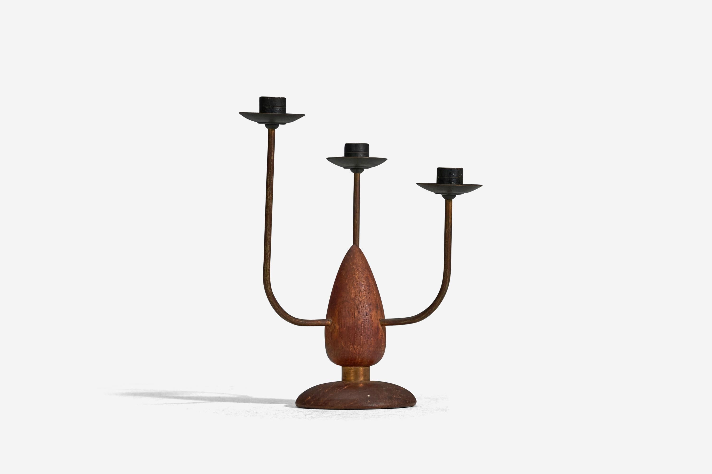 A teak and brass candelabra designed and produced in Denmark, 1940s.